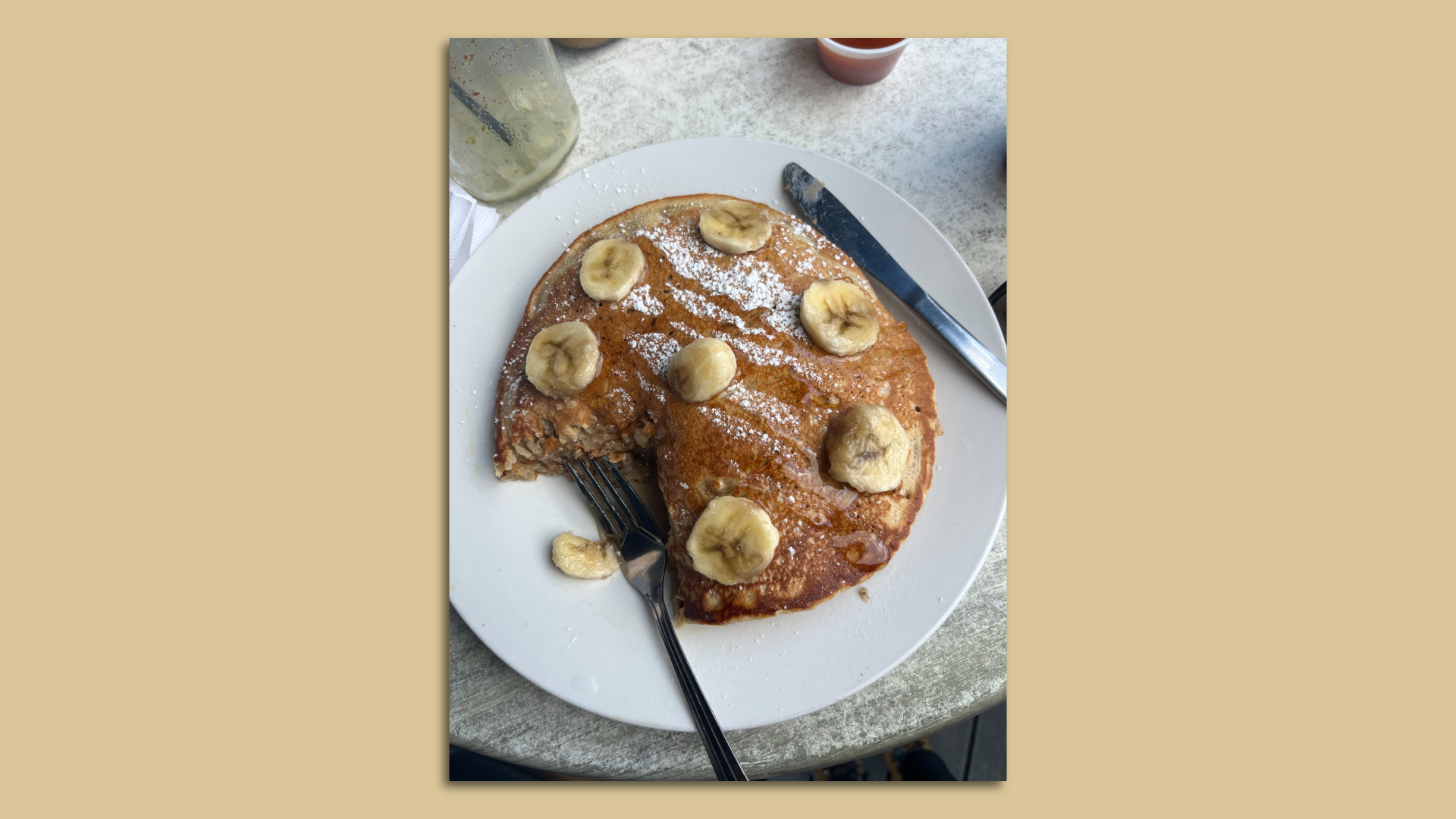 A photo of a bite taken out of vegan banana pancakes.