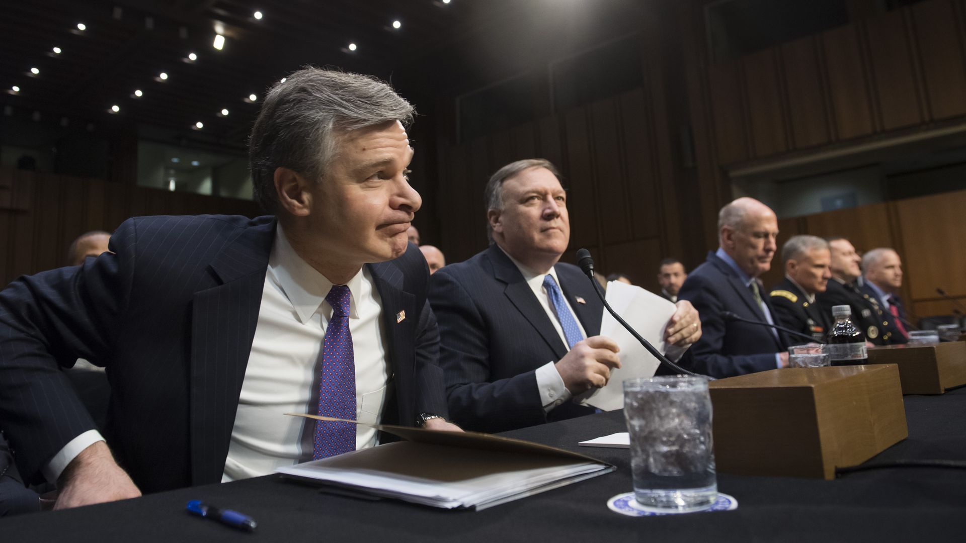Intelligence and law enforcement officials seated at a hearing table