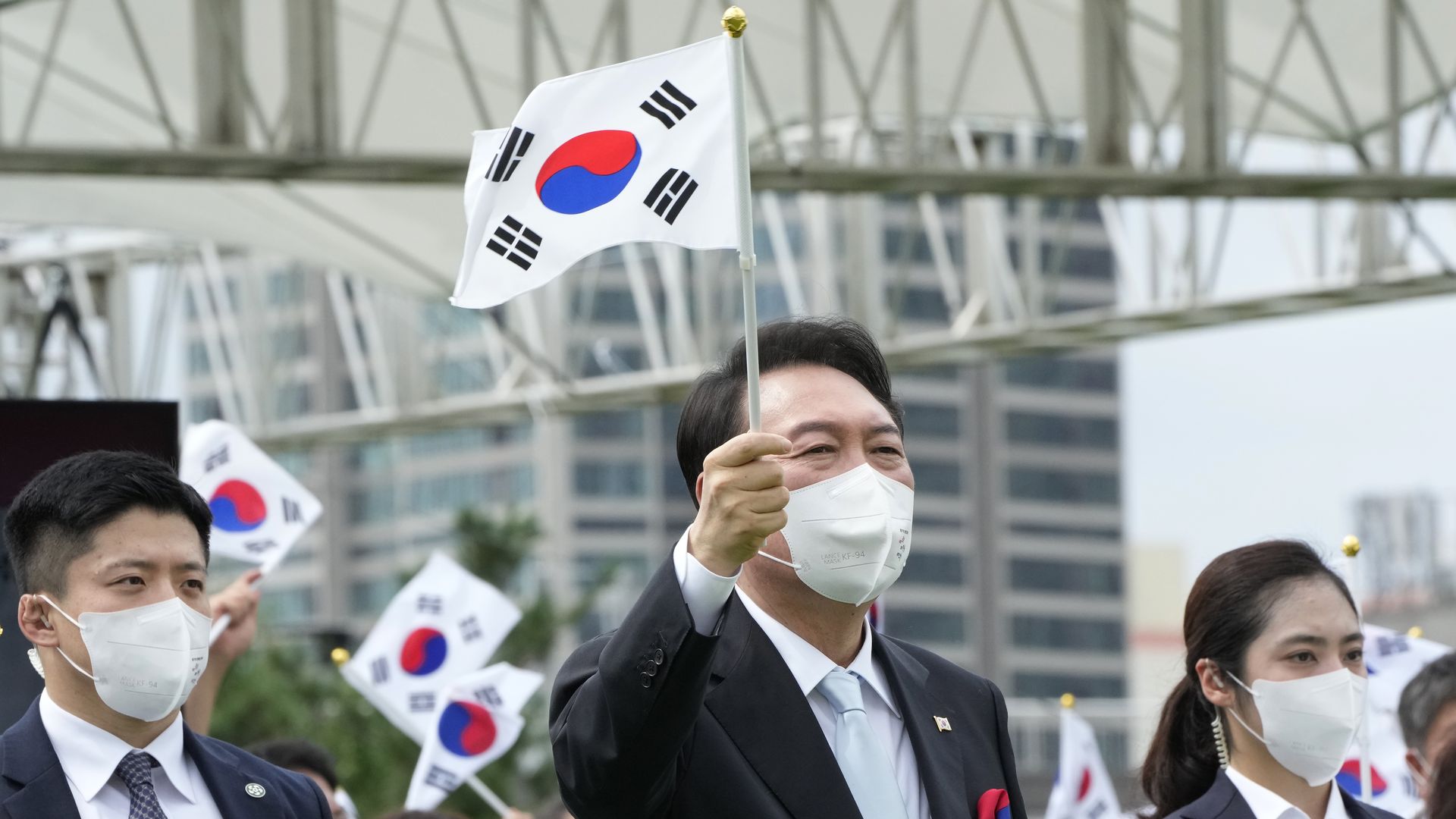 South Korean President Yoon Suk Yeol waves a national flag during the celebration of the 77th National Liberation Day at Presidential House on August 15 in Seoul.