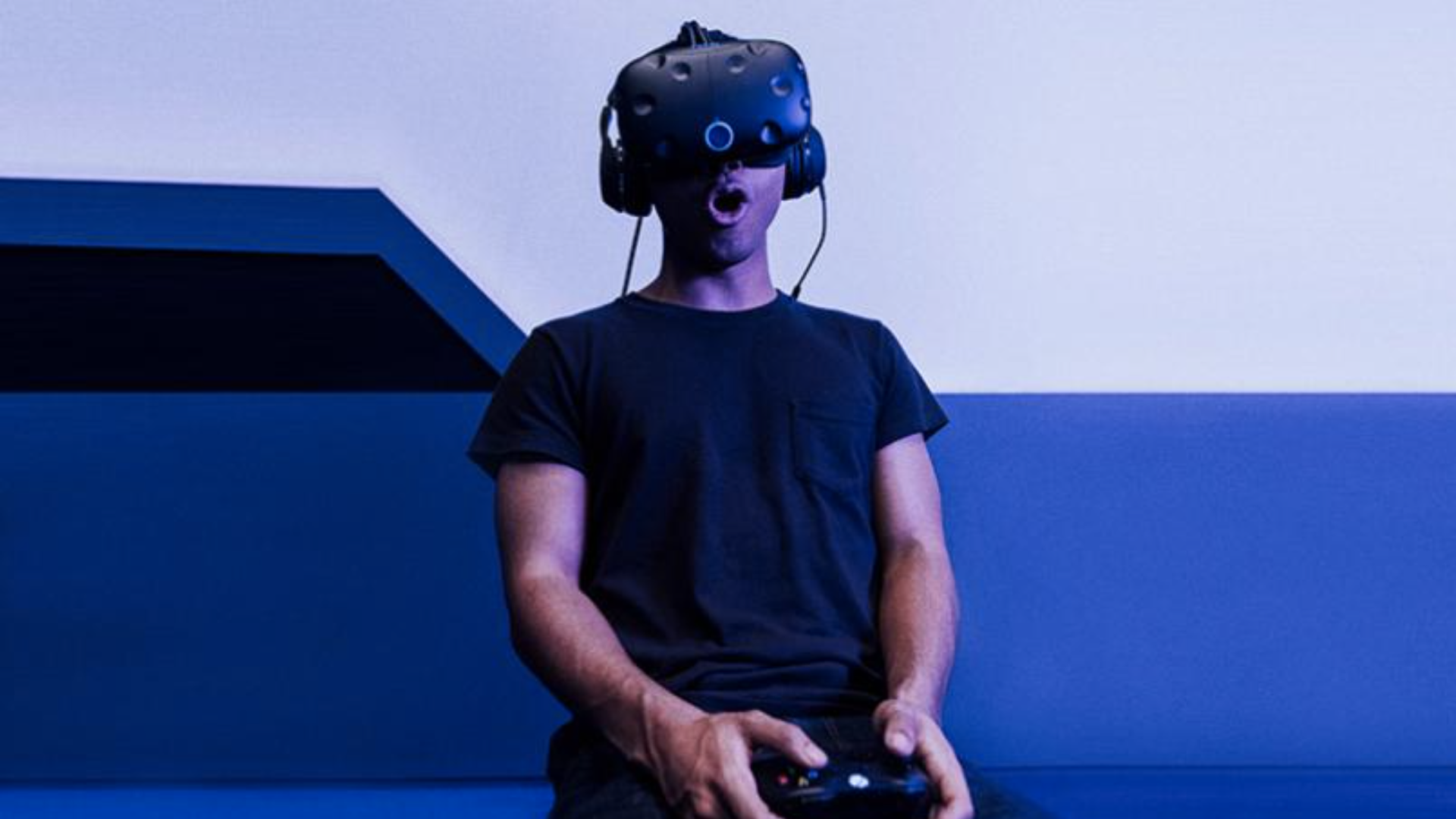 A man wearing a VR headset and looking surprised