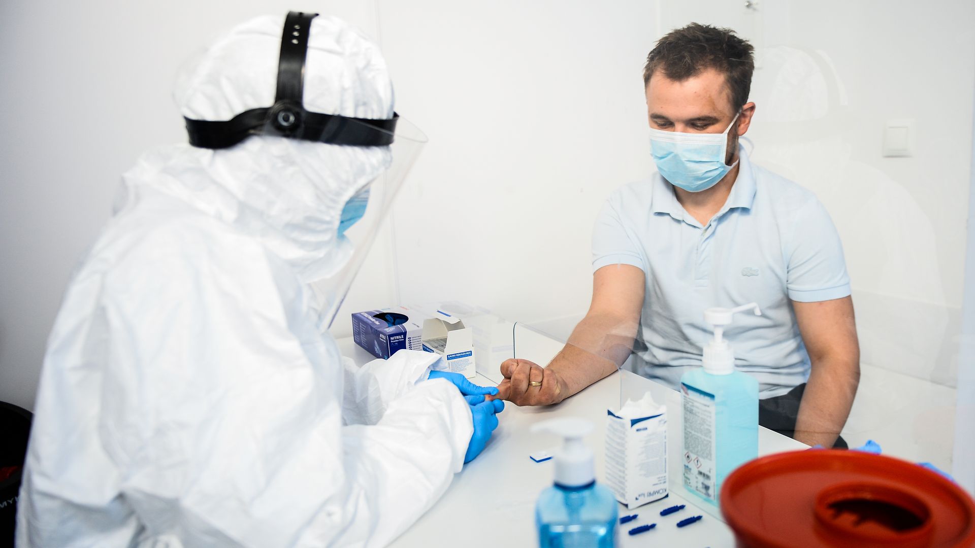A health worker extracting blood from a patient for a coronavirus antibody test in Krakow, Poland, in April 2020.