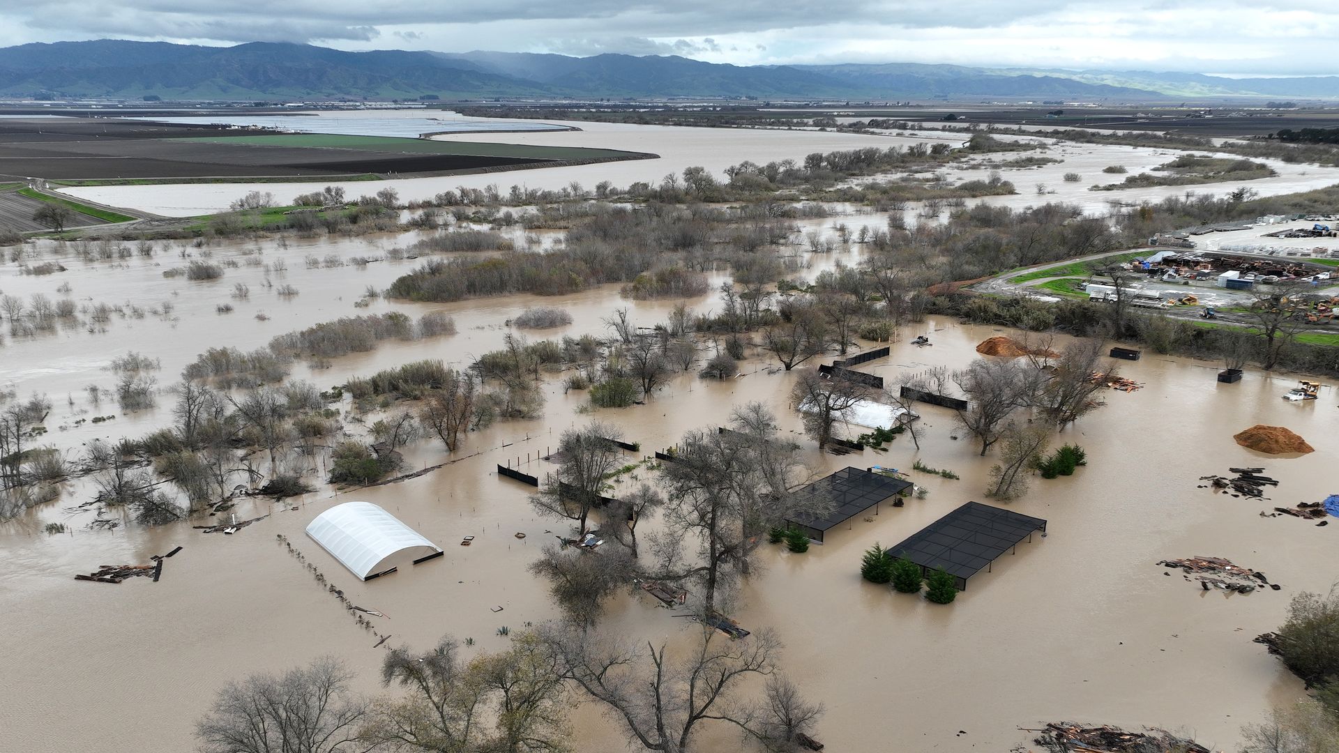 In an aerial view, floodwaters cover an agricultural area after the Salinas River overflowed its banks on January 13, 2023 in Salinas, California.