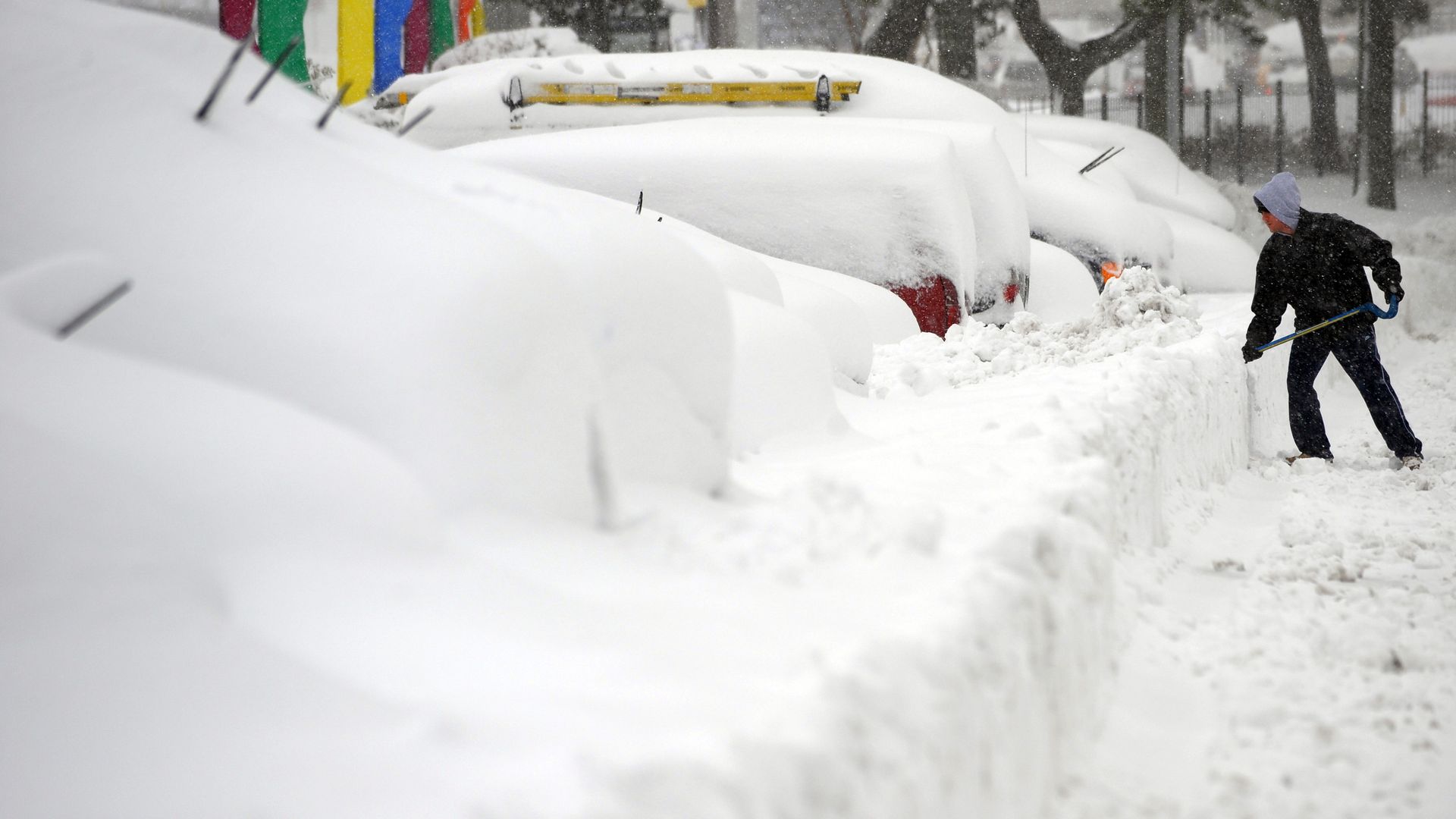 A man digs out cars after a blizzard in February 2010 in Silver Spring, Maryland.