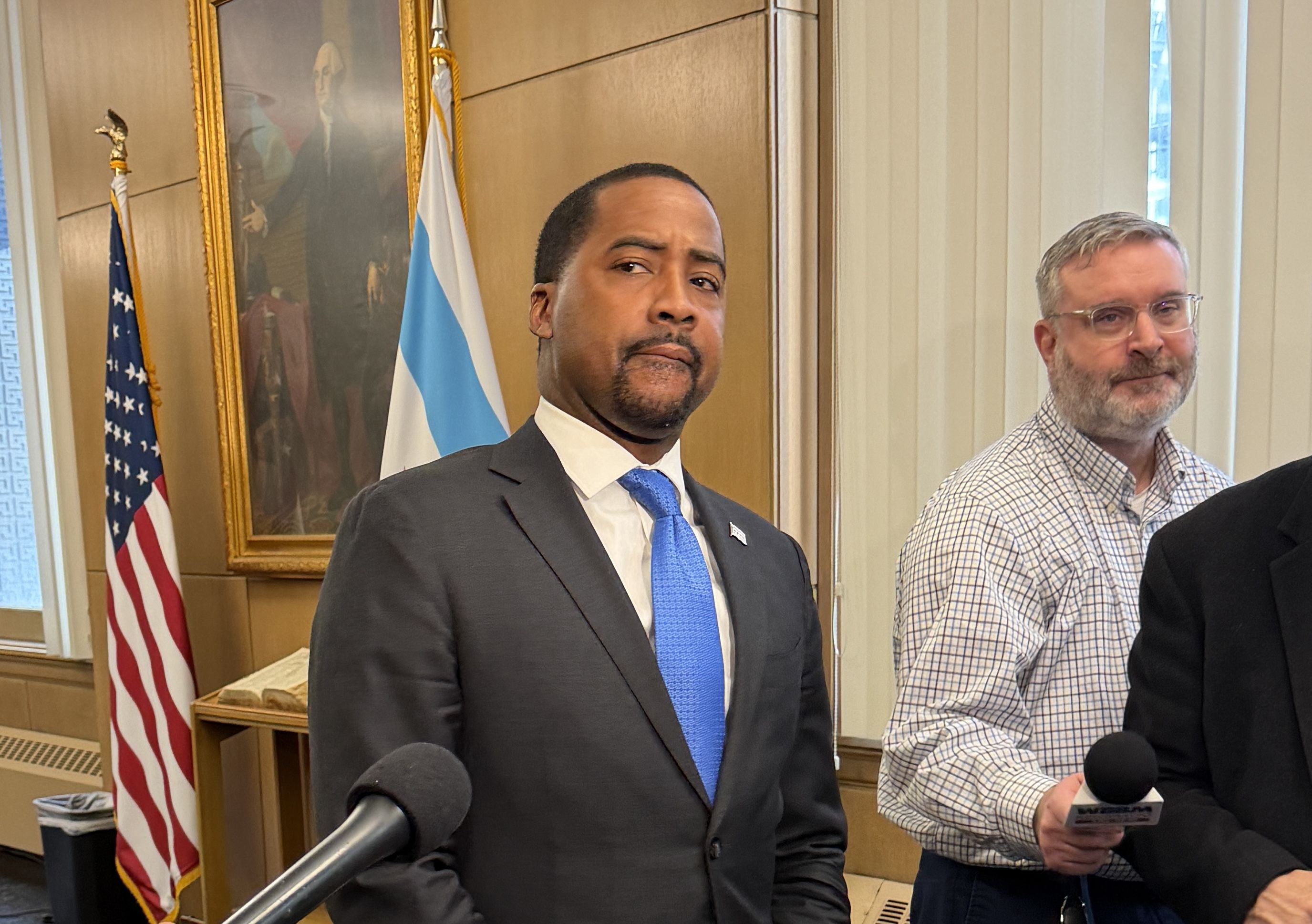 man in a grey suit and blue tie 