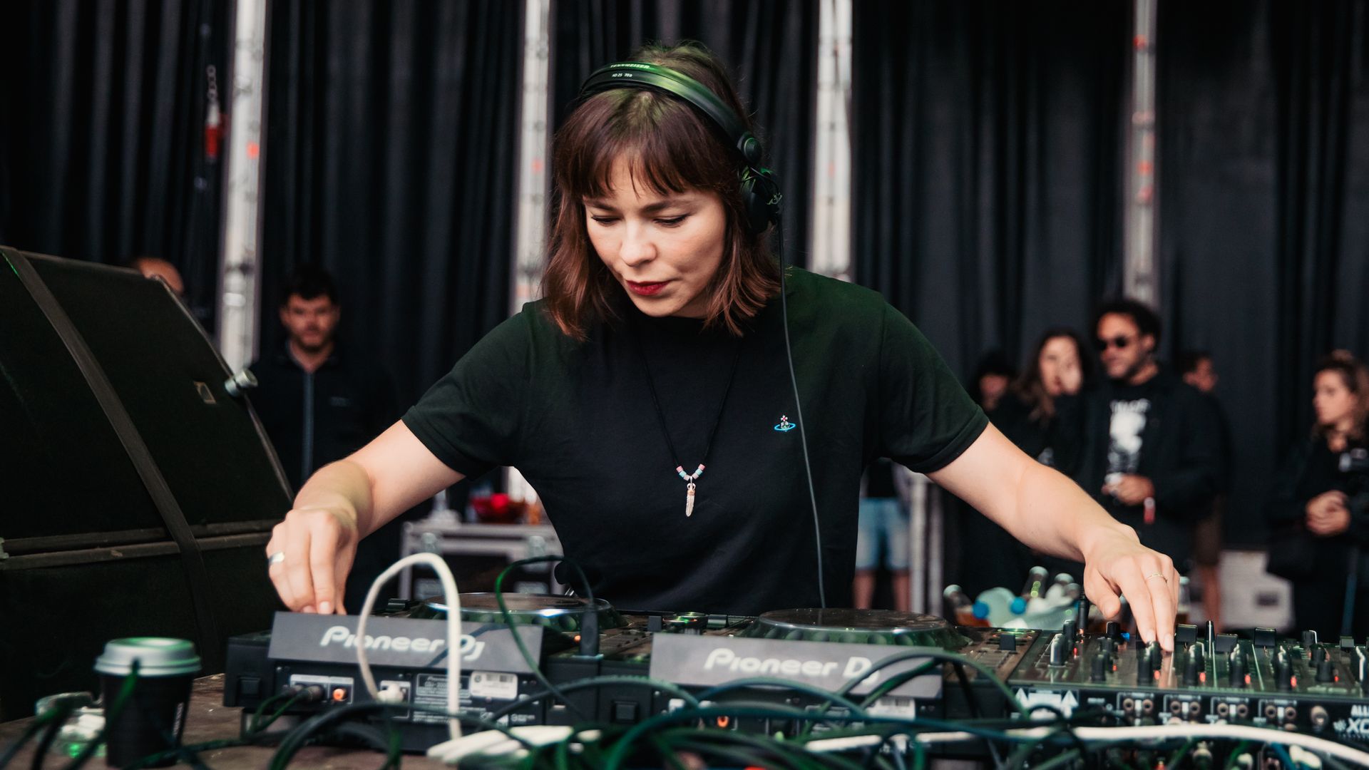 Nina Kraviz DJs at a table.