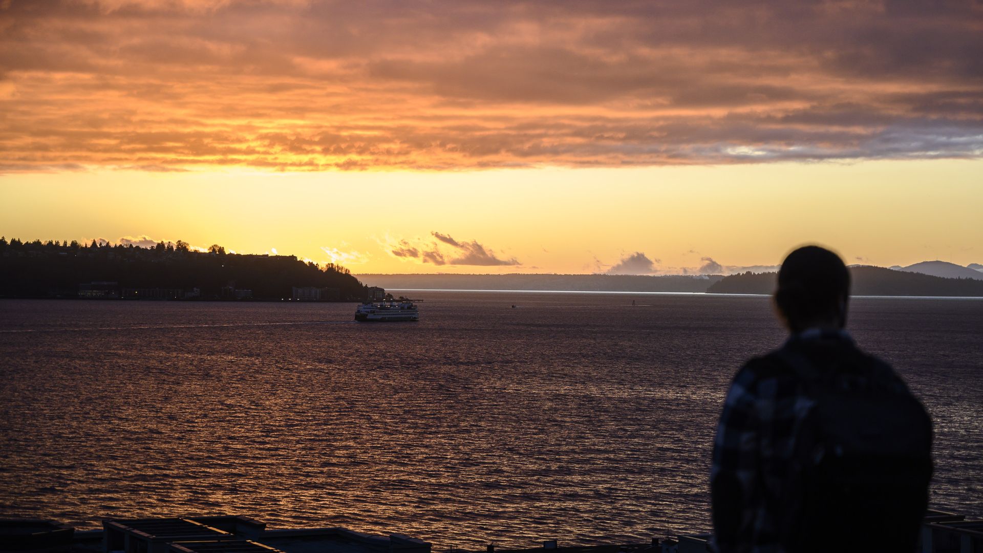Outline of person watching the sunset from Seattle.  
