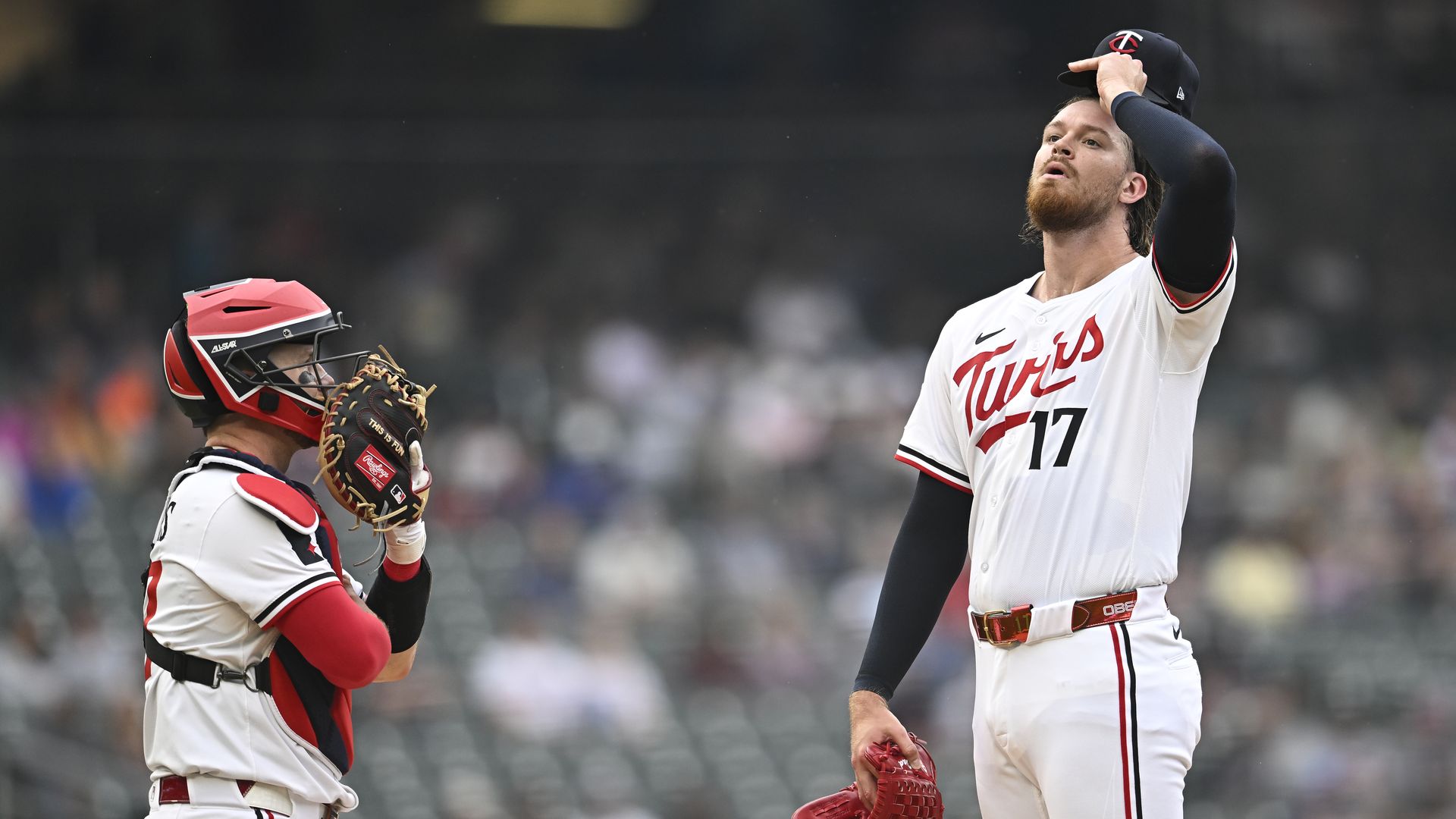 A photo of Ryan Jeffers talking to Bailey Ober on the mound. Ober looks frustrated 