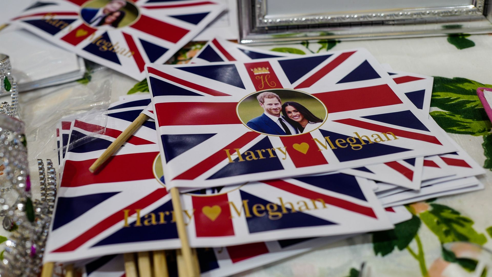 Flags bearing the image of Great Britain's Prince Harry and US actress Meghan Markle