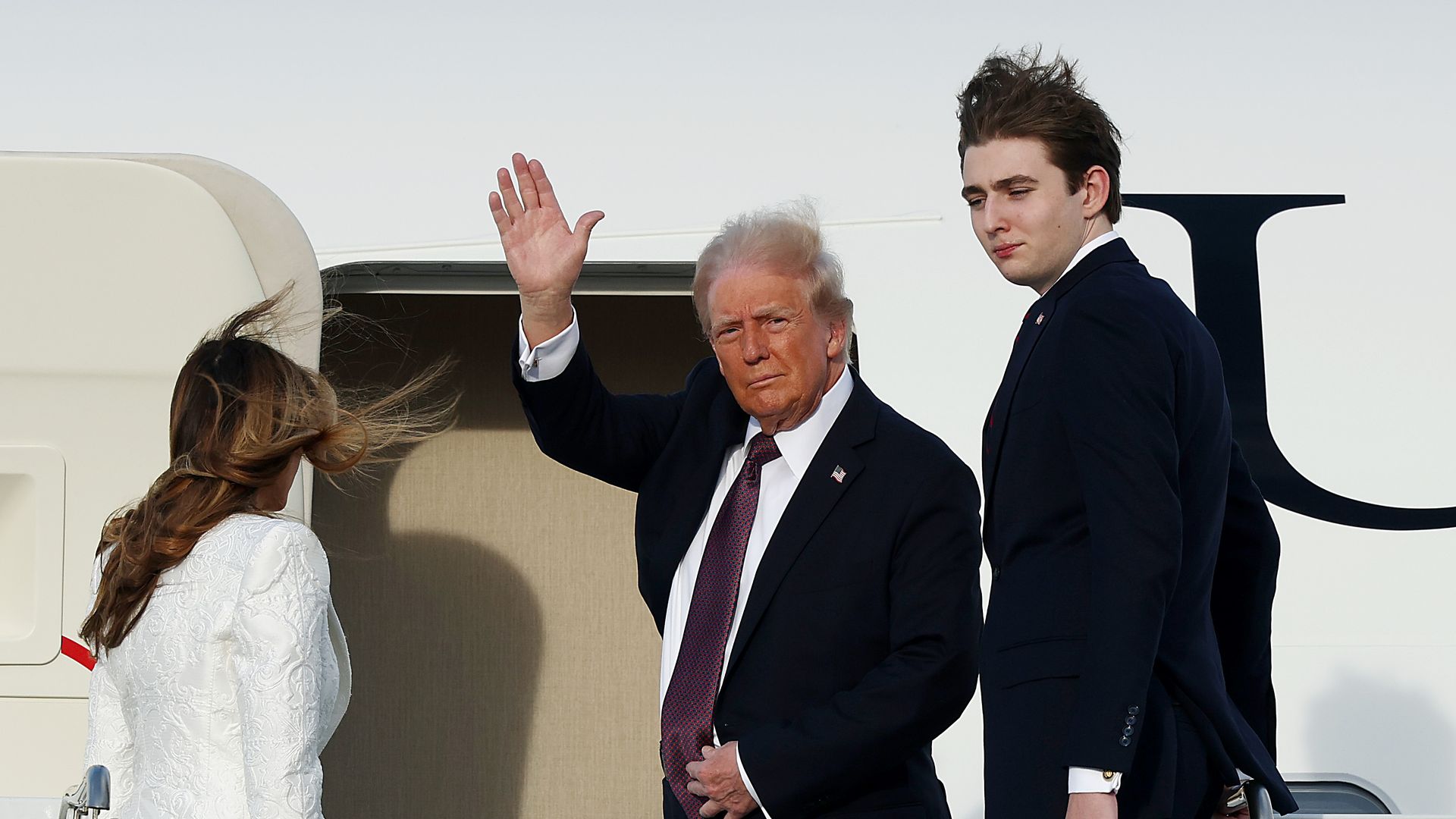 President-elect Donald Trump, Melania Trump and their son Barron board a U.S. Air Force aircraft en route to Dulles, Virginia on January 18, 2025 in West Palm Beach, Florida. 
