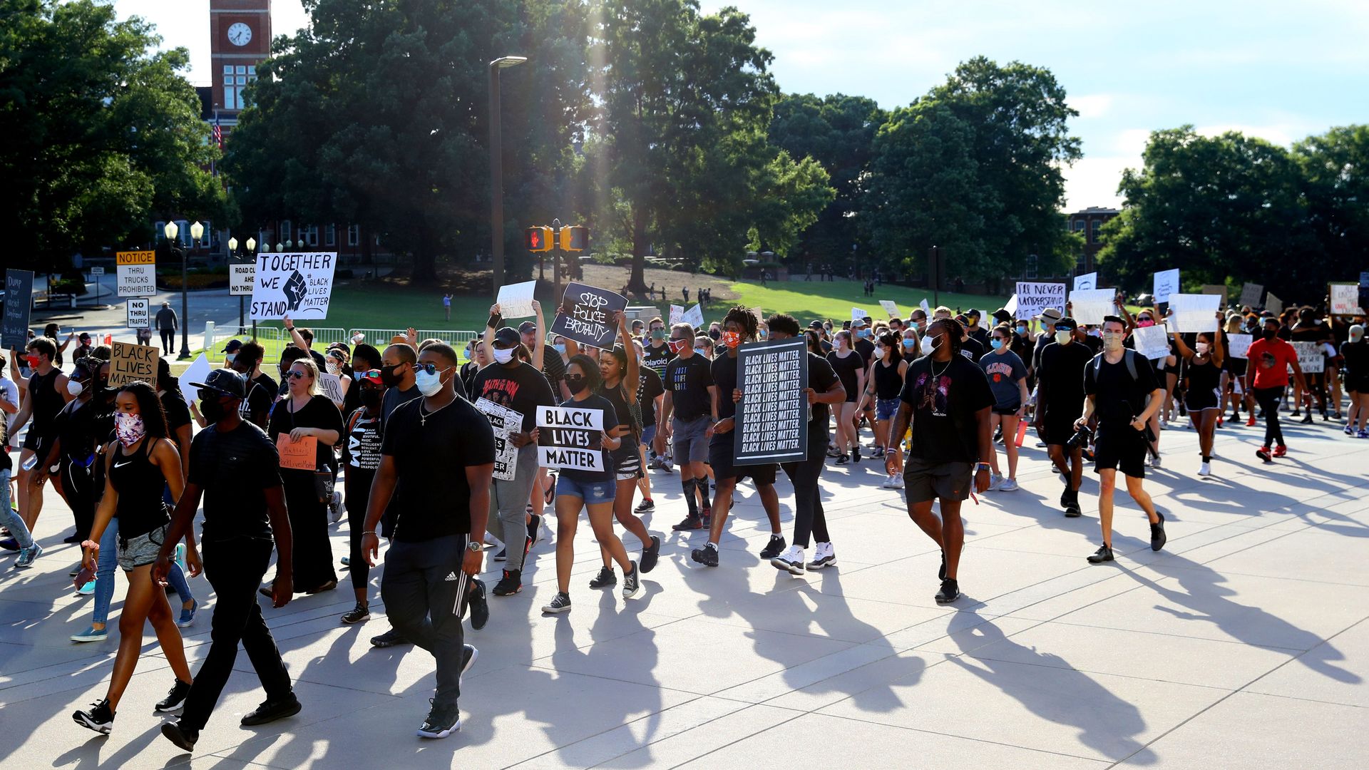 Clemson football players lead a "March for Change" protest past Tillman Hall on June 13.