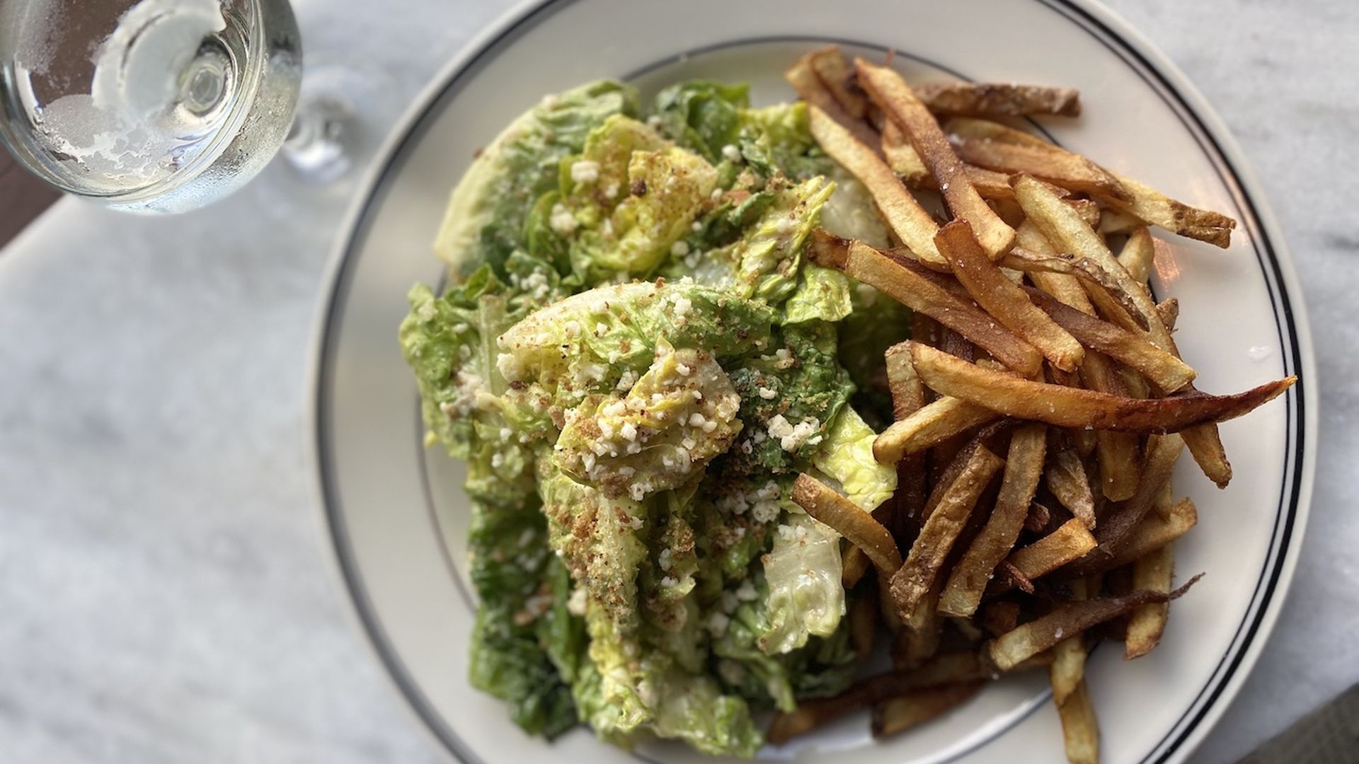 A Caesar salad, French fries and a martini 