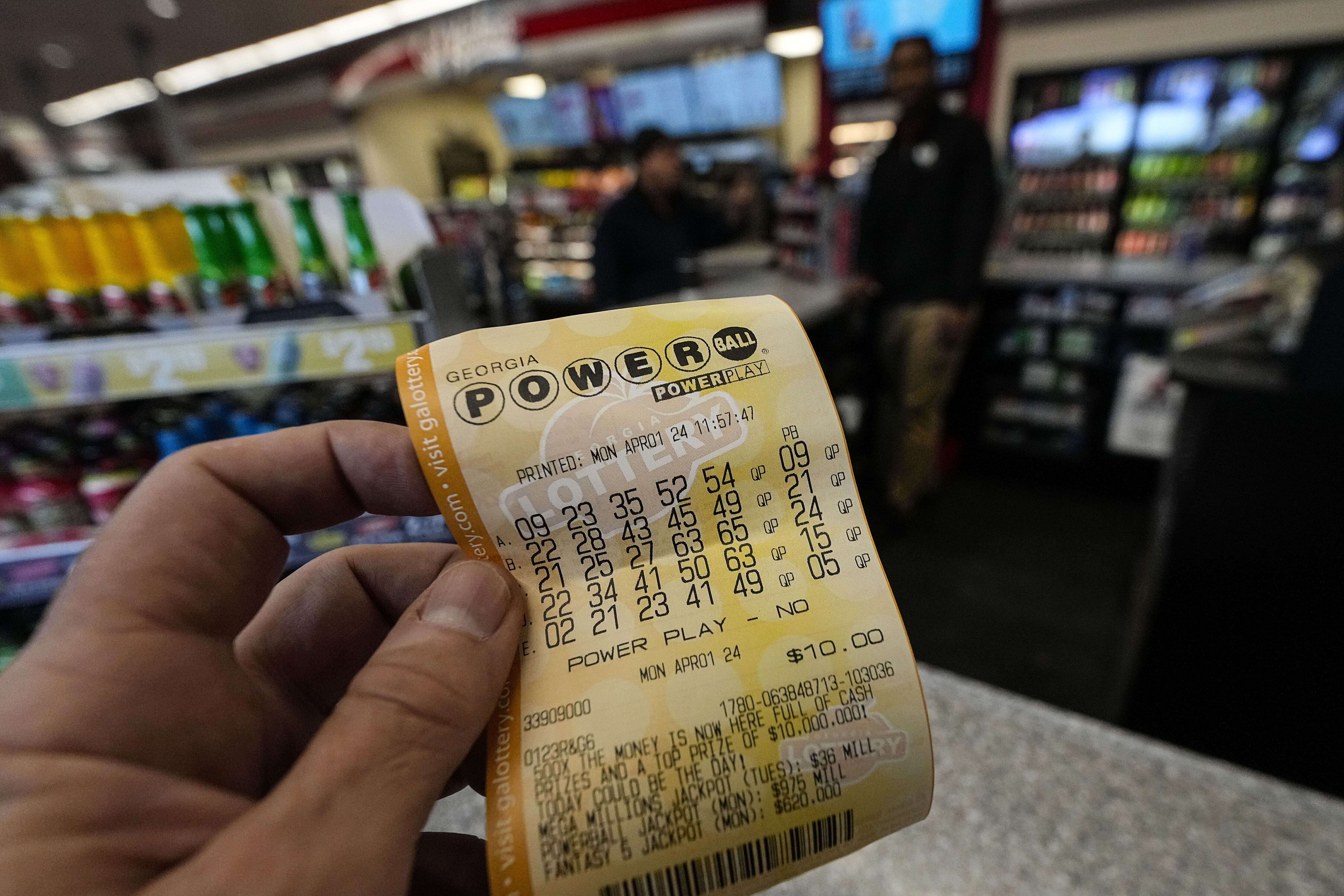 FILE - A Powerball lottery ticket is dipslayed seen inside a convenience store, Monday, April 1, 2024, in Kennesaw, Ga. An estimated $1.09 billion Powerball jackpot that ranks as the 9th largest in U.S. lottery history will be up for grabs Wednesday night, April 3. (AP Photo/Mike Stewart, FIle)