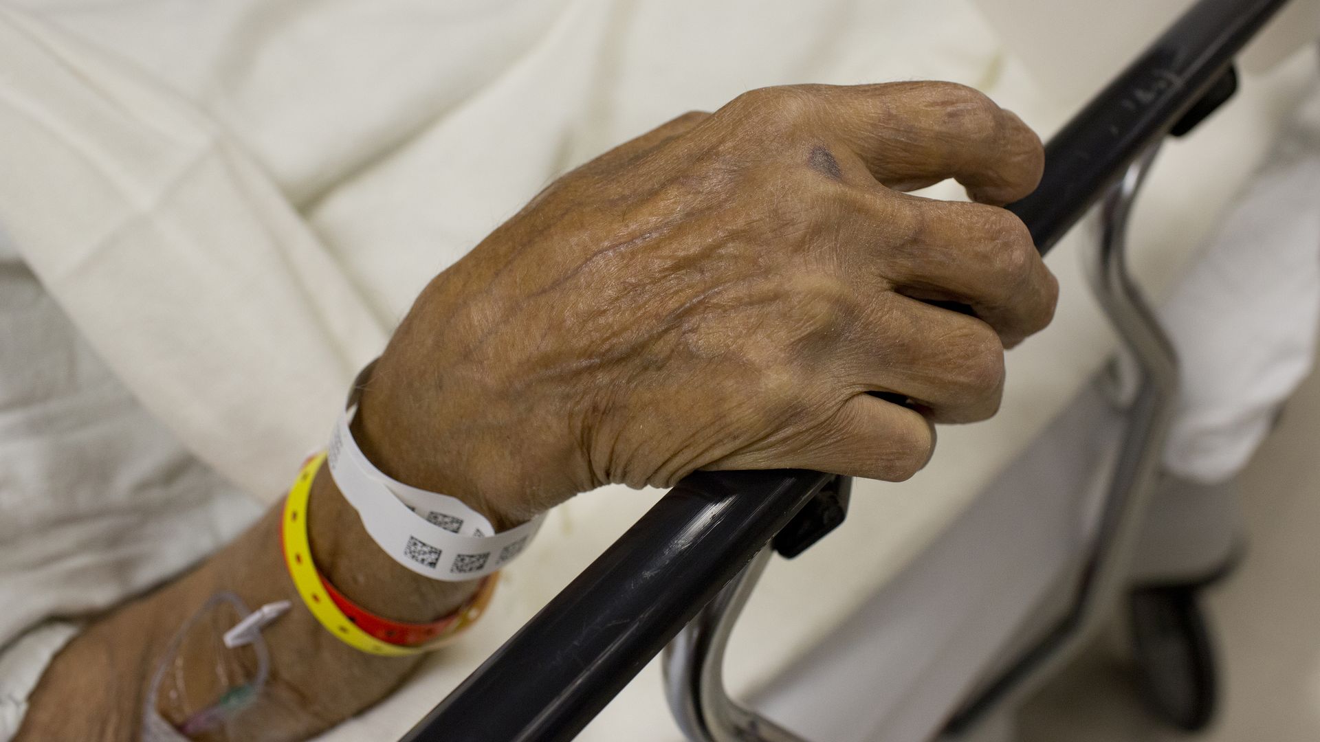 Old man's hand with hospital bracelets