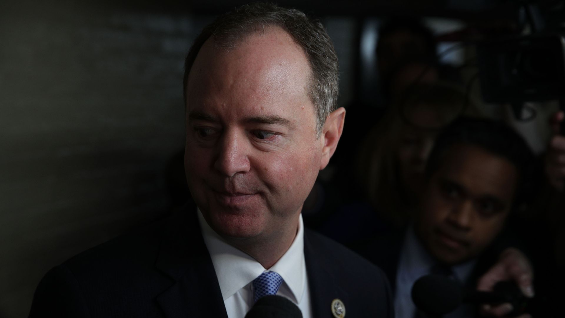 In this image, Adam Schiff looks down while wearing a suit.