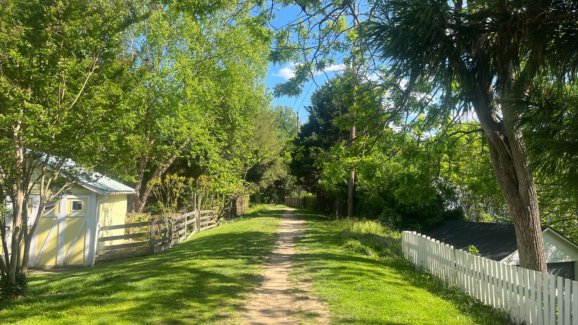 The beginning of the trail is a narrow path between houses and yards