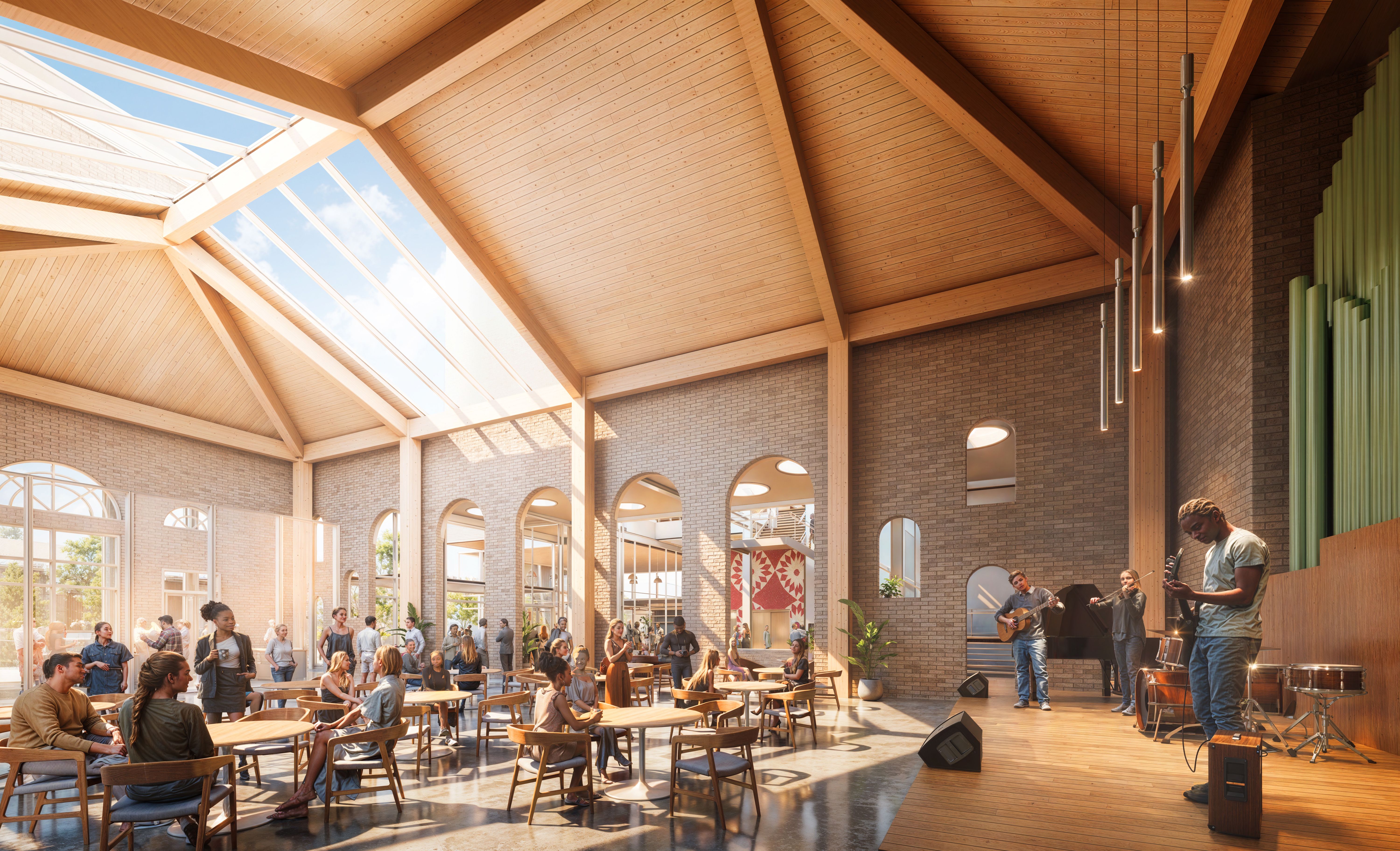 Bright cafe with wooden beams and skylights, people sitting at round wooden tables, and a band with guitar, violin, and bass guitar performing on a wooden stage with hanging lights.