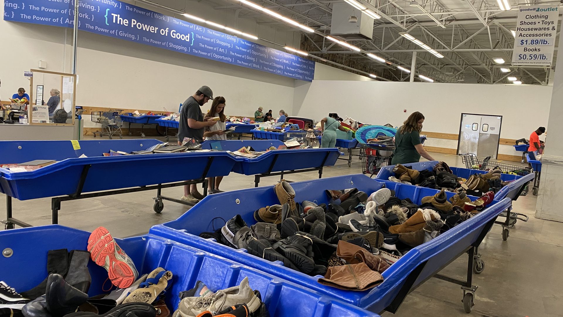 Rows of blue Goodwill bins full of shoes
