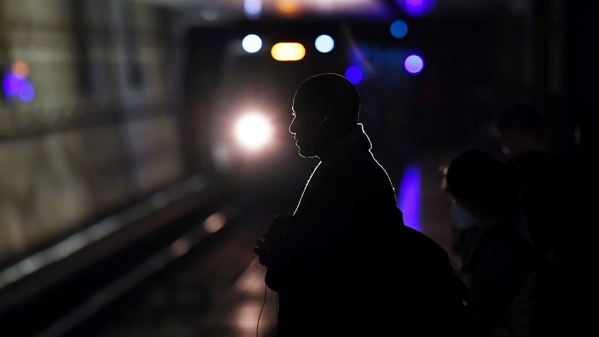 A passenger waits for a Metro train.