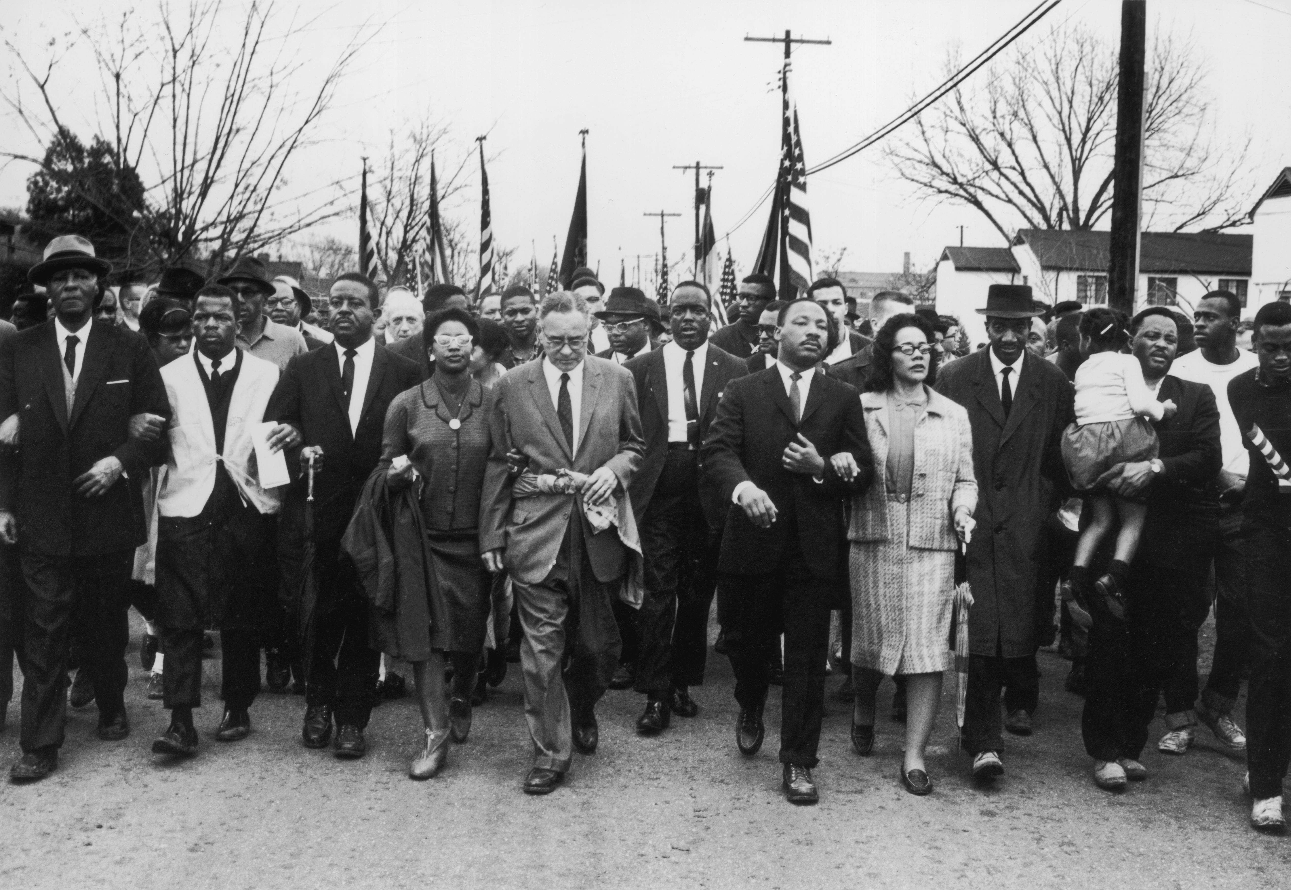Martin Luther King, Jr., and his wife Coretta Scott King lead a black voting rights march on March 30, 1965, in Alabama.