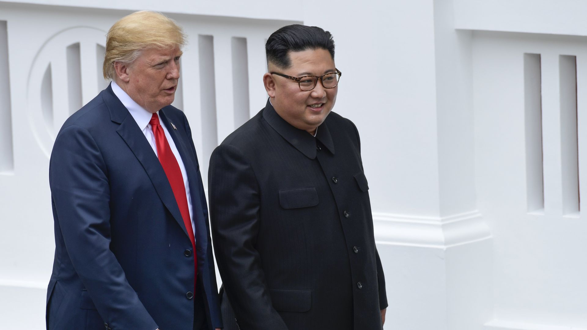 US President Donald Trump and North Korea leader Kim Jong Un walk from lunch at the Capella resort on Sentosa Island in Singapore
