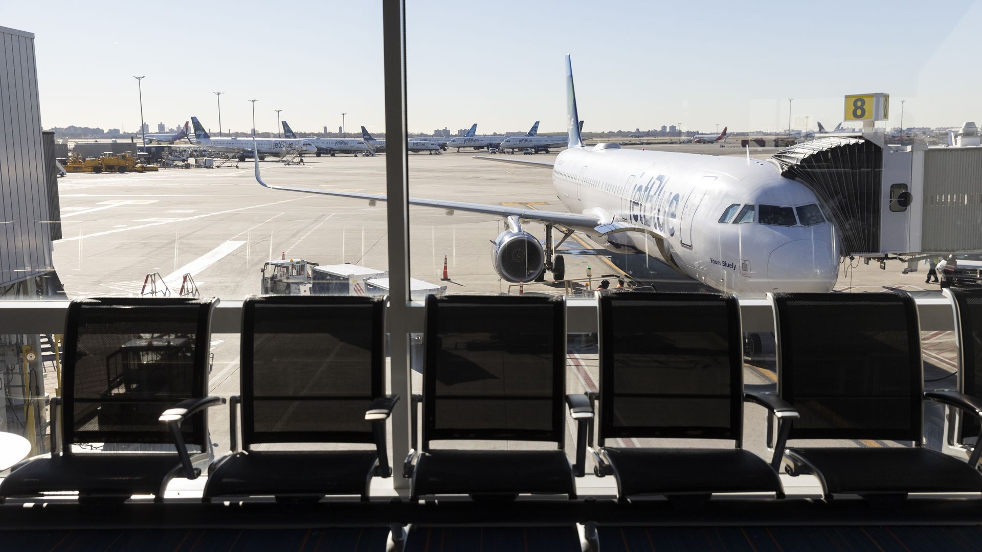 A plane seen outside an airport window