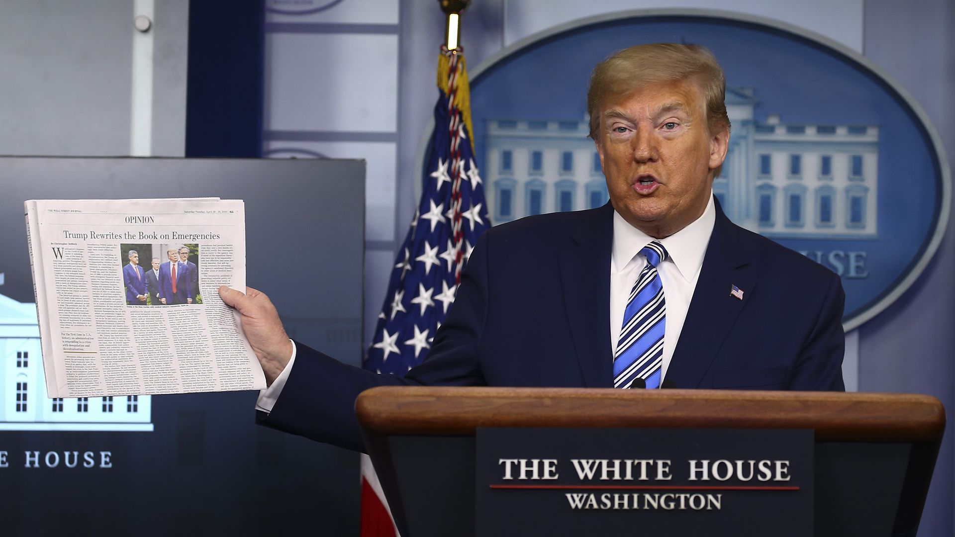 Picture of Donald Trump holding a print copy of the Wall Street Journal