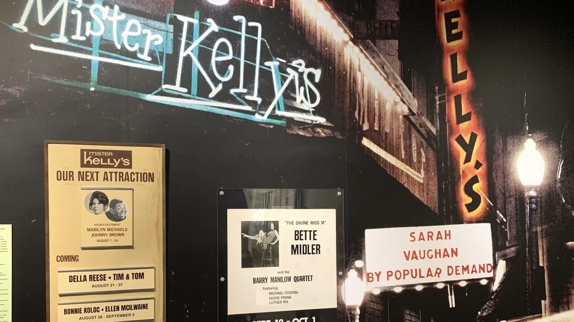 Board with neon signs and old posters