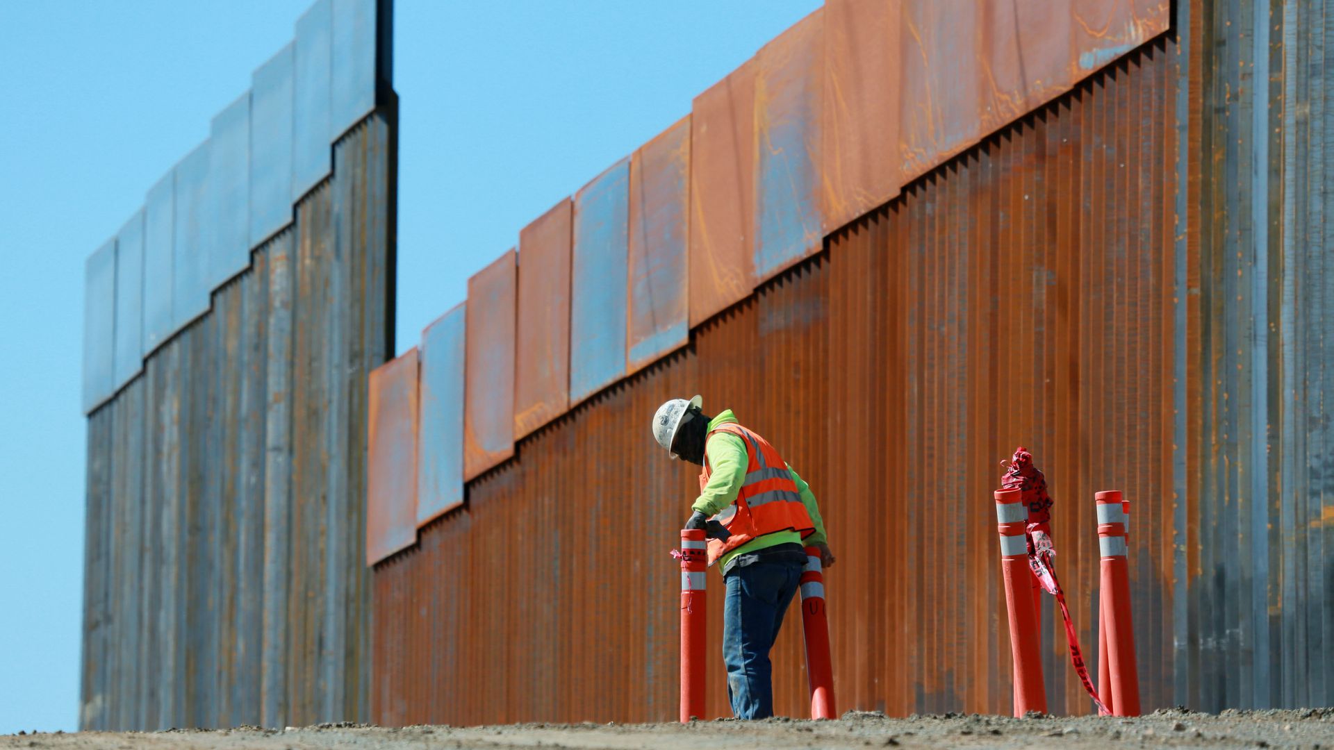 Construction worker build a secondary border wall in February in Otay Mesa, California. 