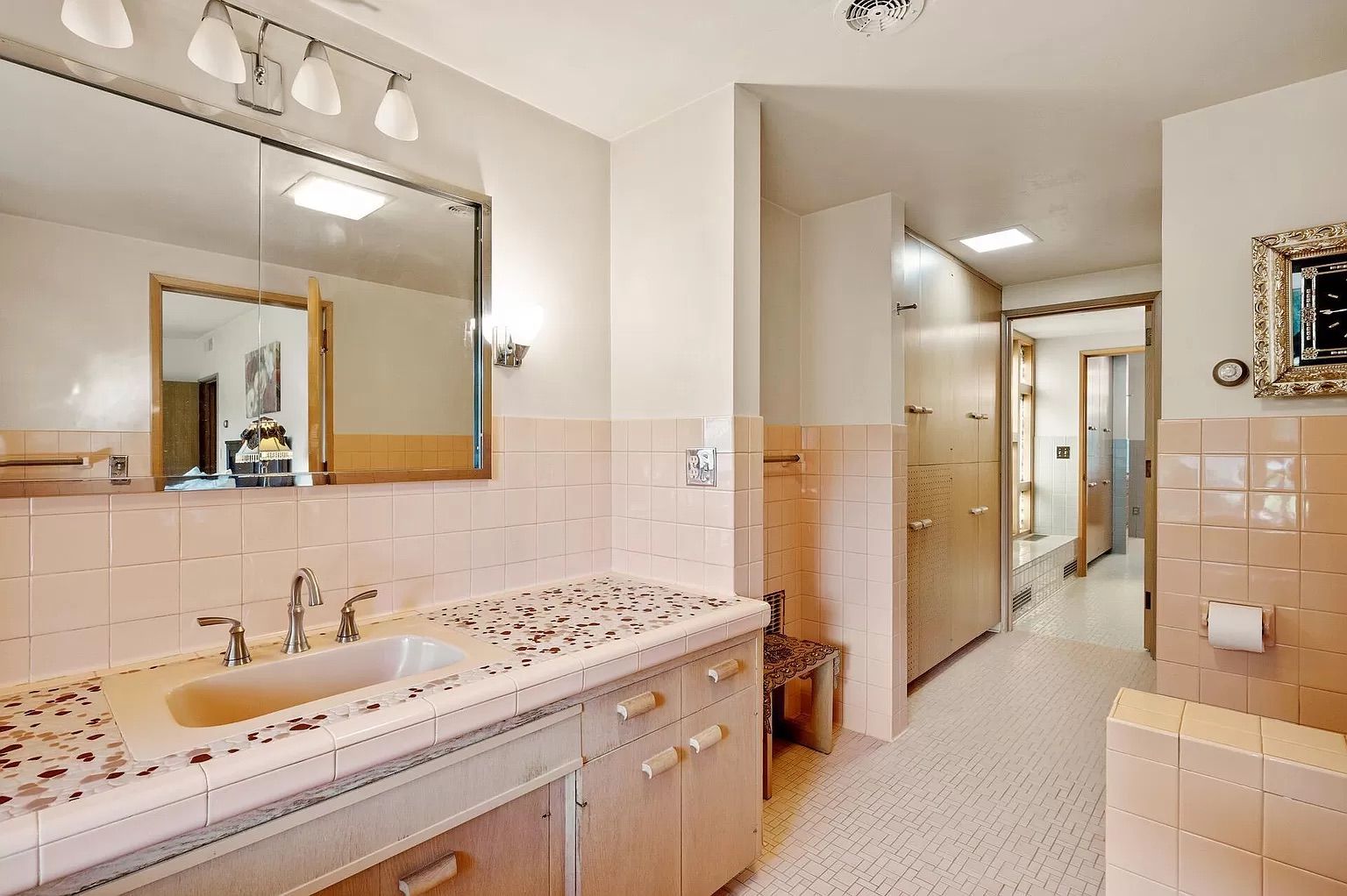 A bathroom with pink square tiles.