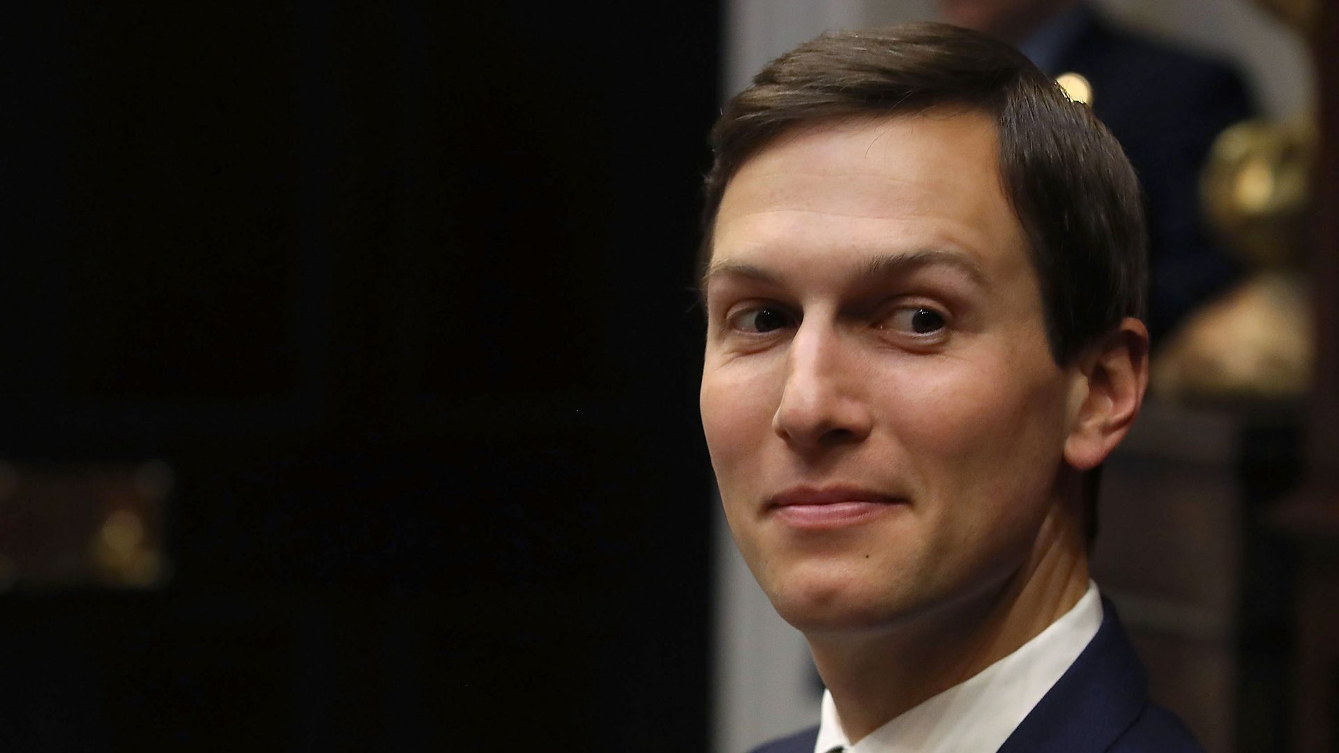 Jared Kushner looks out of the corner of his eye with a smile