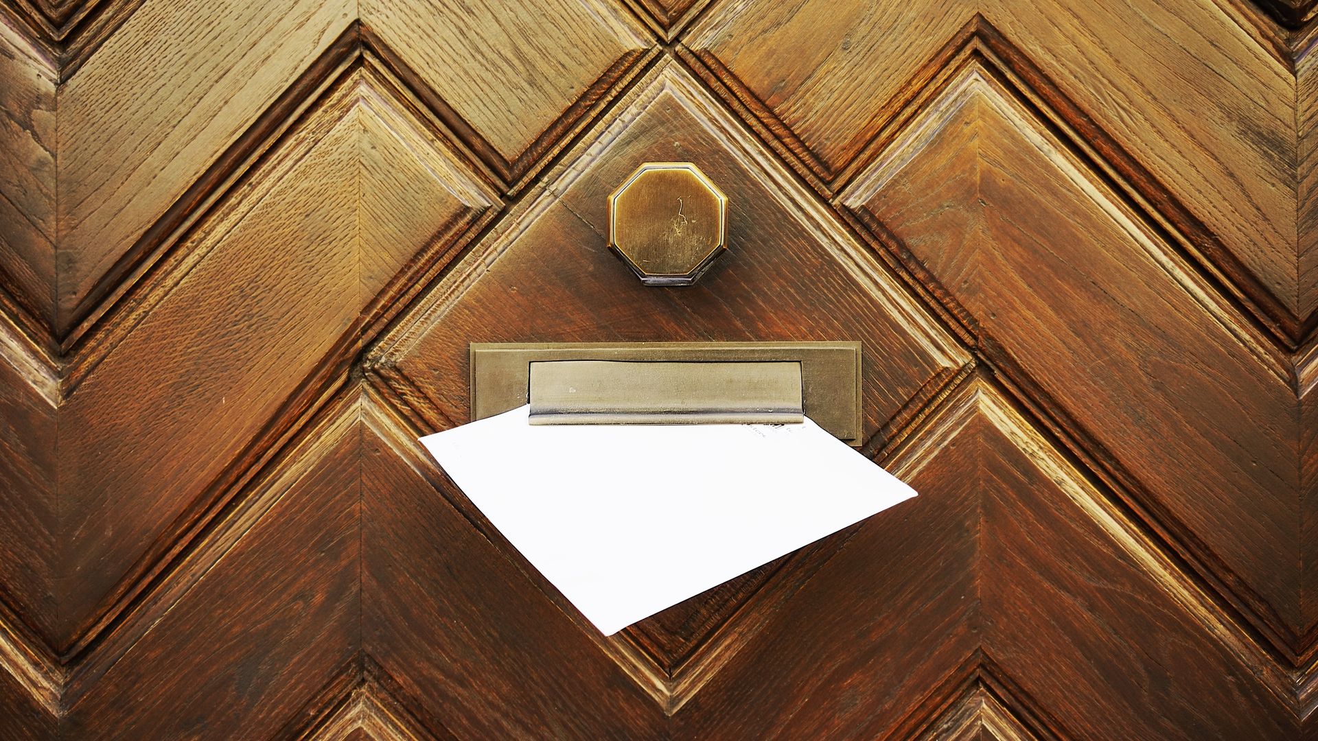 Letter box on a door with a mail sticking out
