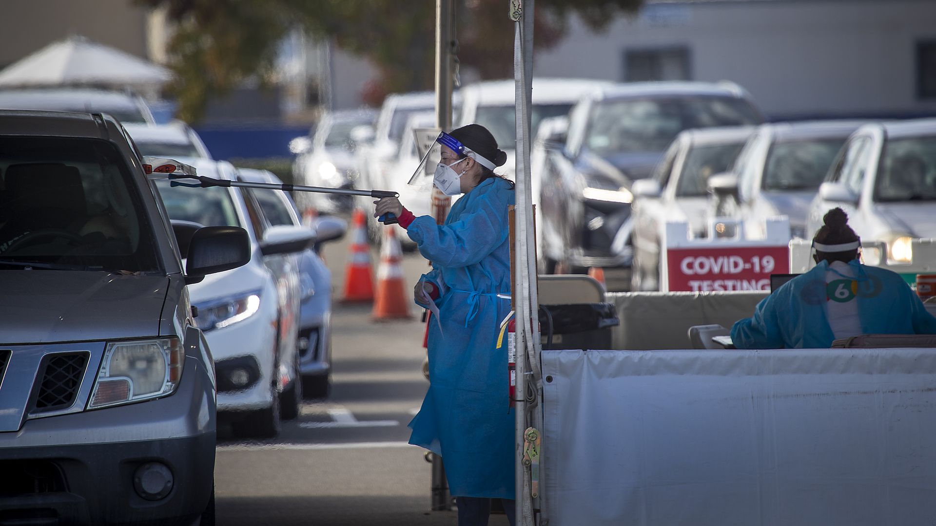 Clinic health care workers working with the Orange County Health Care Agency and city of Costa Mesa conducts testing at the drive-through self-administered COVID-19 testing super site in Orange County