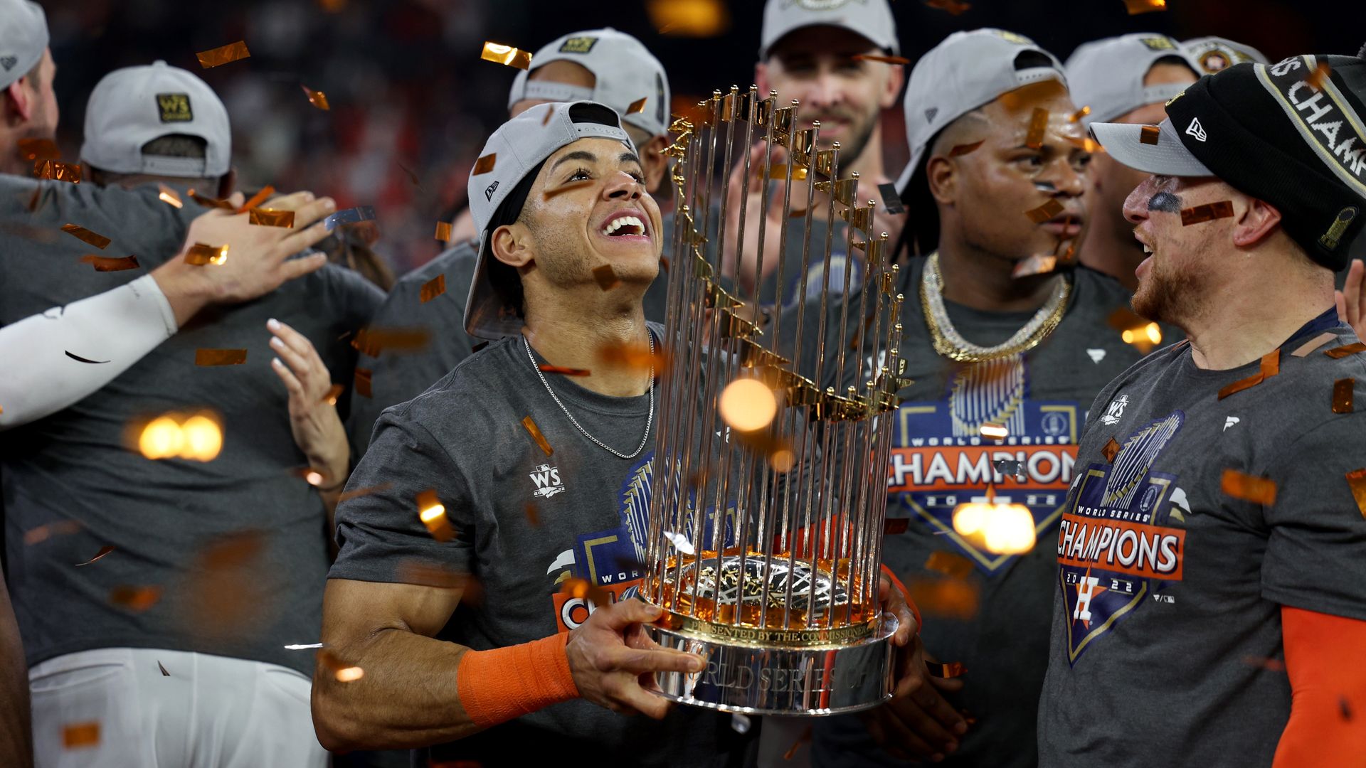 Astros shortstop and World Series MVP Jeremy Peña hoists the Commissioners Trophy midfield as confetti rains down after the Astros won the World Series