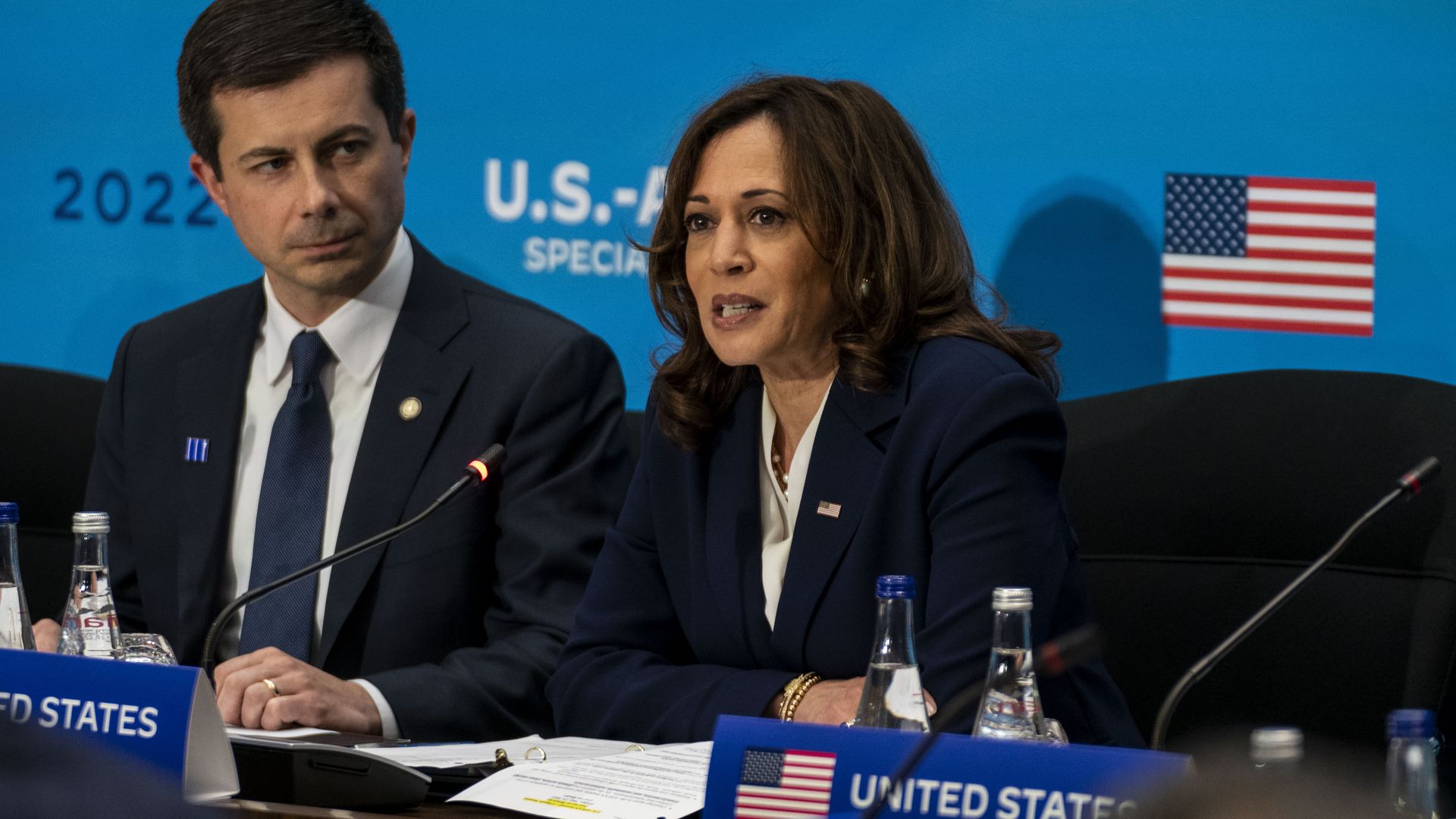 VP Harris speaks as Transportation Secy. Pete Buttigieg watches.