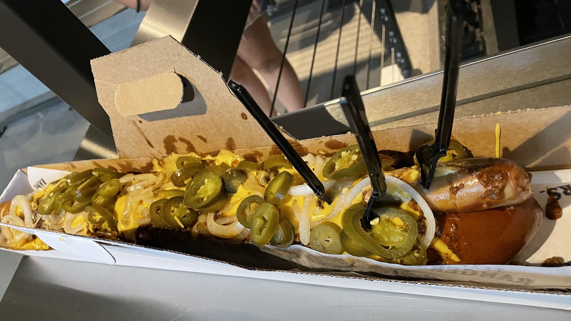 A massive got dog with several forks stuck in it