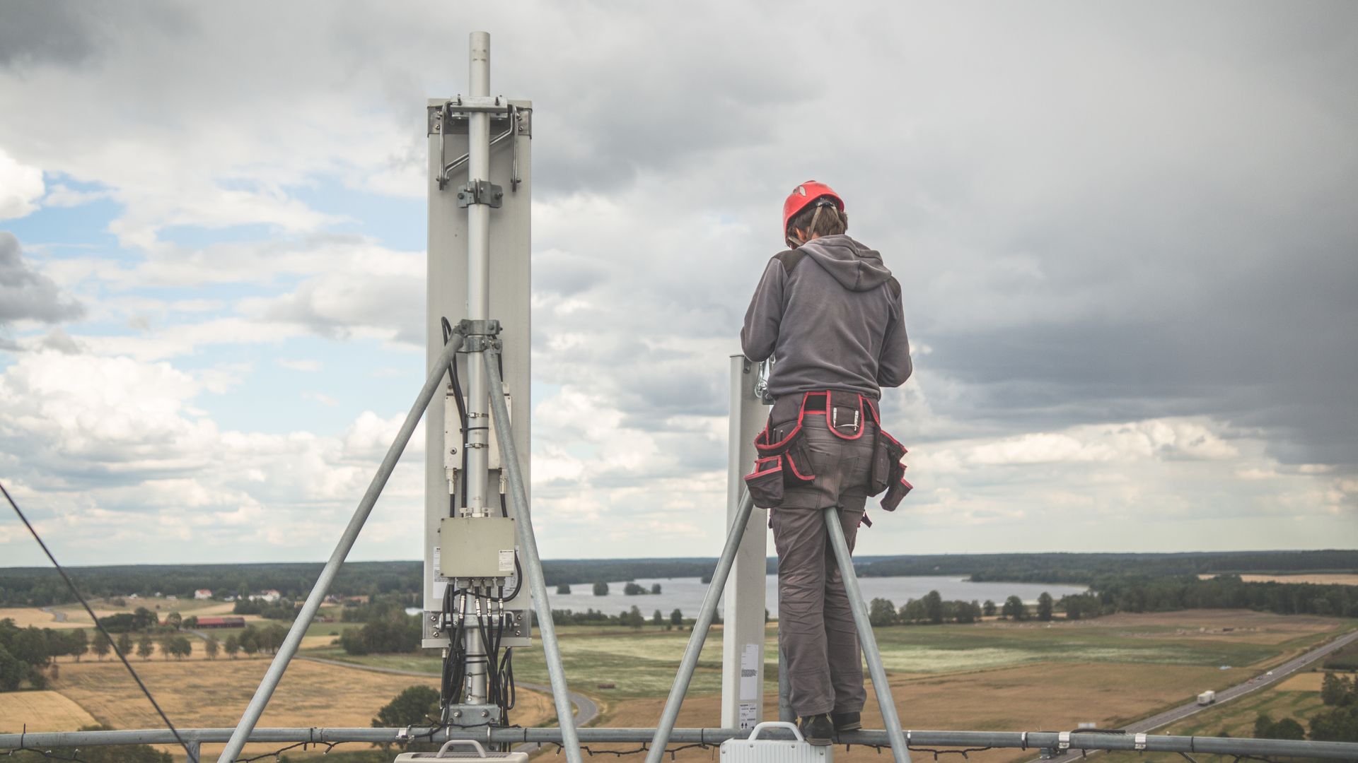 Telecom worker installs equipment