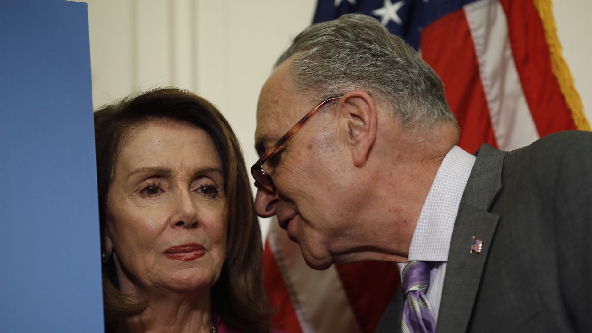 Photo of Nancy Pelosi and Chuck Schumer talking.