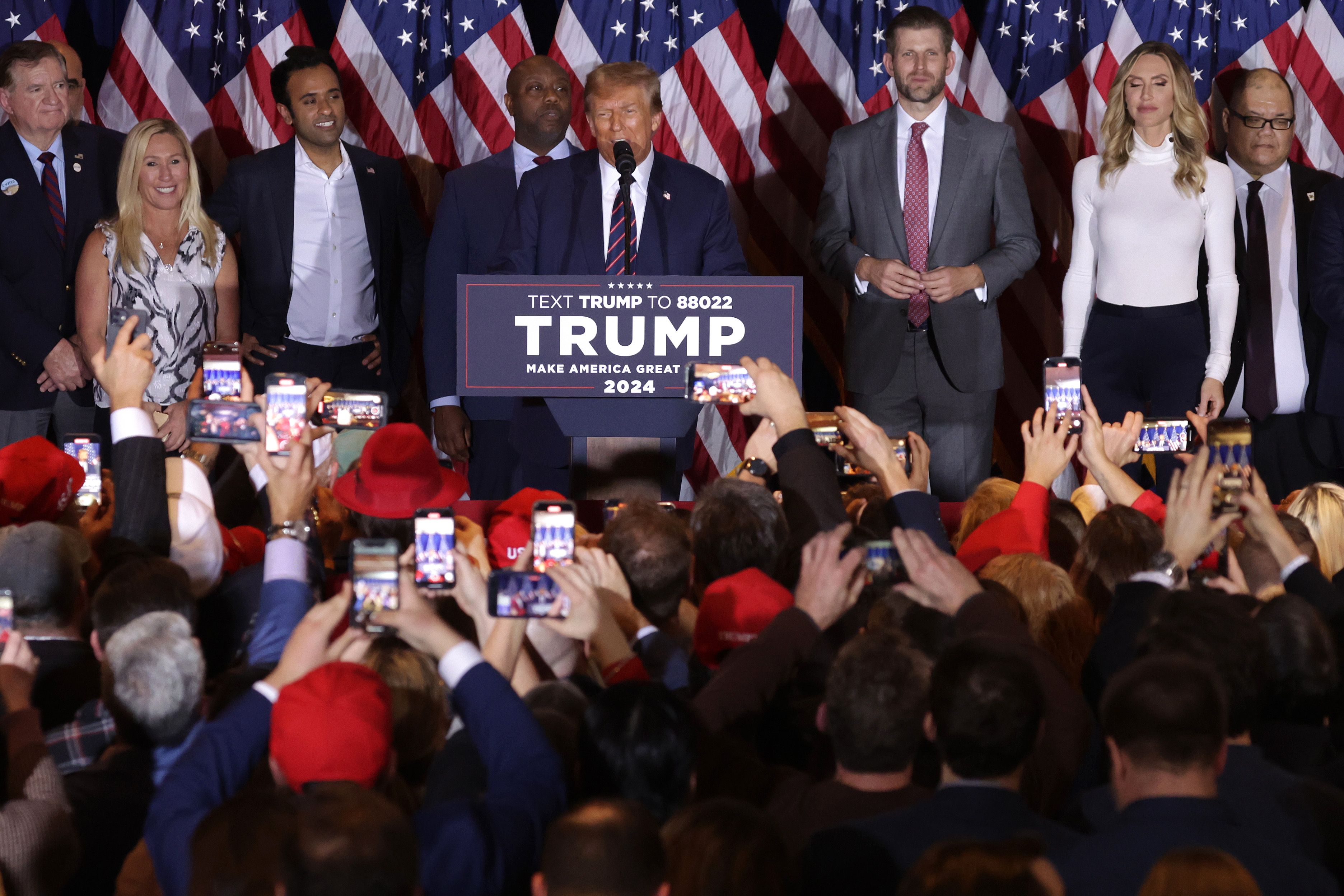 Republican presidential candidate and former U.S. President Donald Trump delivers remarks alongside supporters, campaign staff and family members during his primary night rally at the Sheraton on January 23, 2024 in Nashua, New Hampshire. 