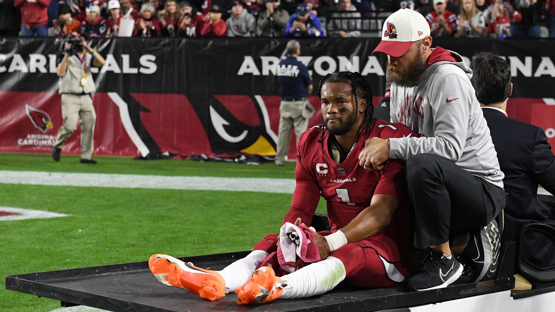 Arizona Cardinals quarterback Kyler Murray sits in the back of a cart after injuring his knee