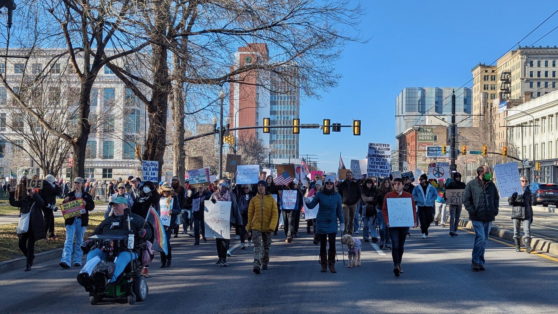 Protesters march on a city street.