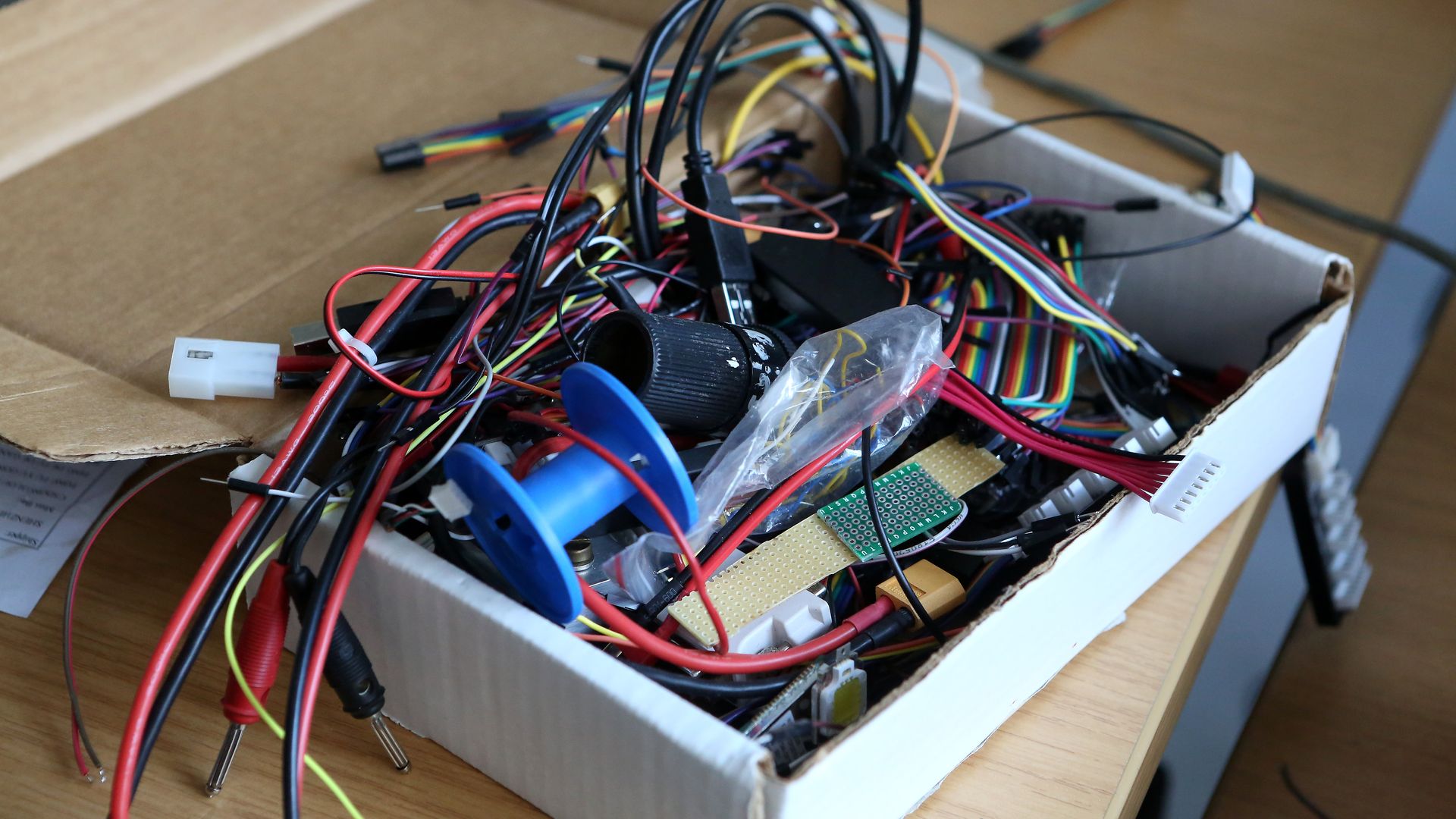 Photo of a box filled with spare electronics parts