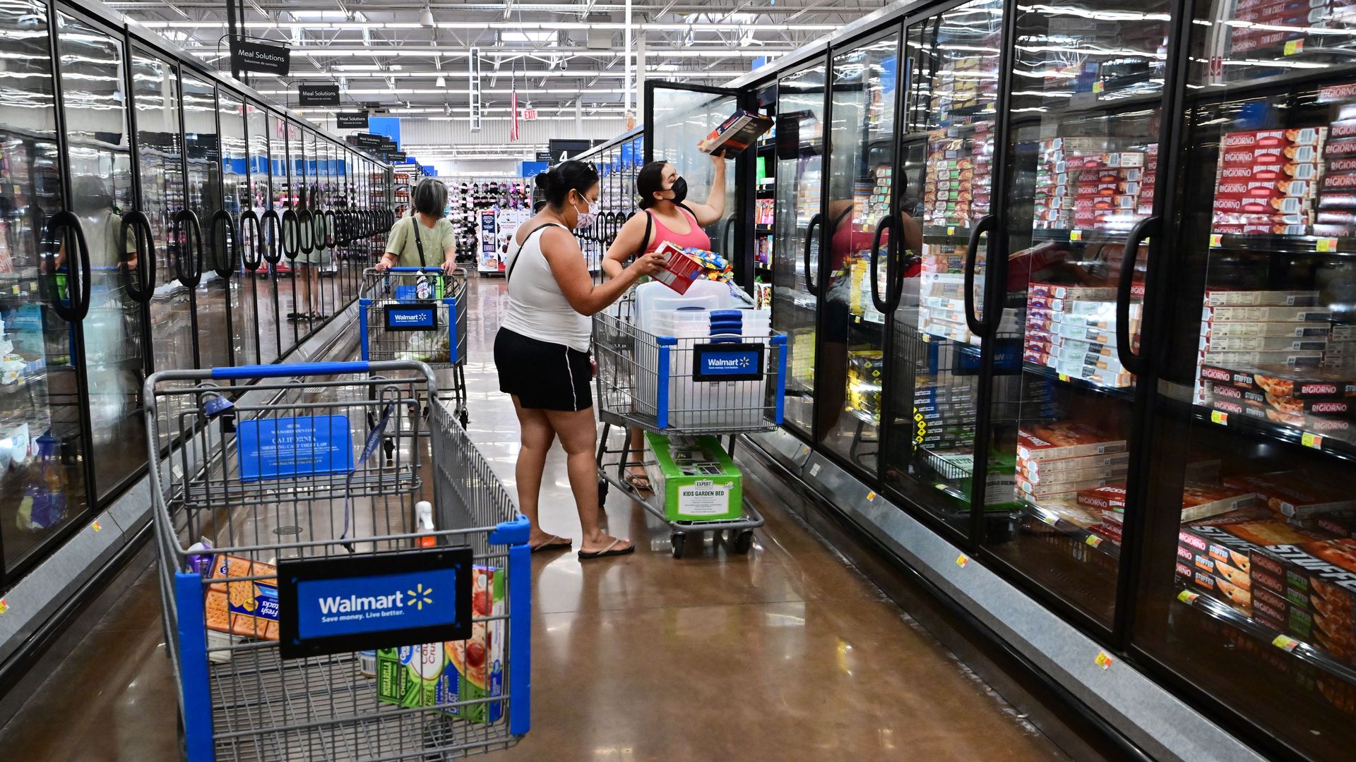 People shop for frozen food at a Walmart store