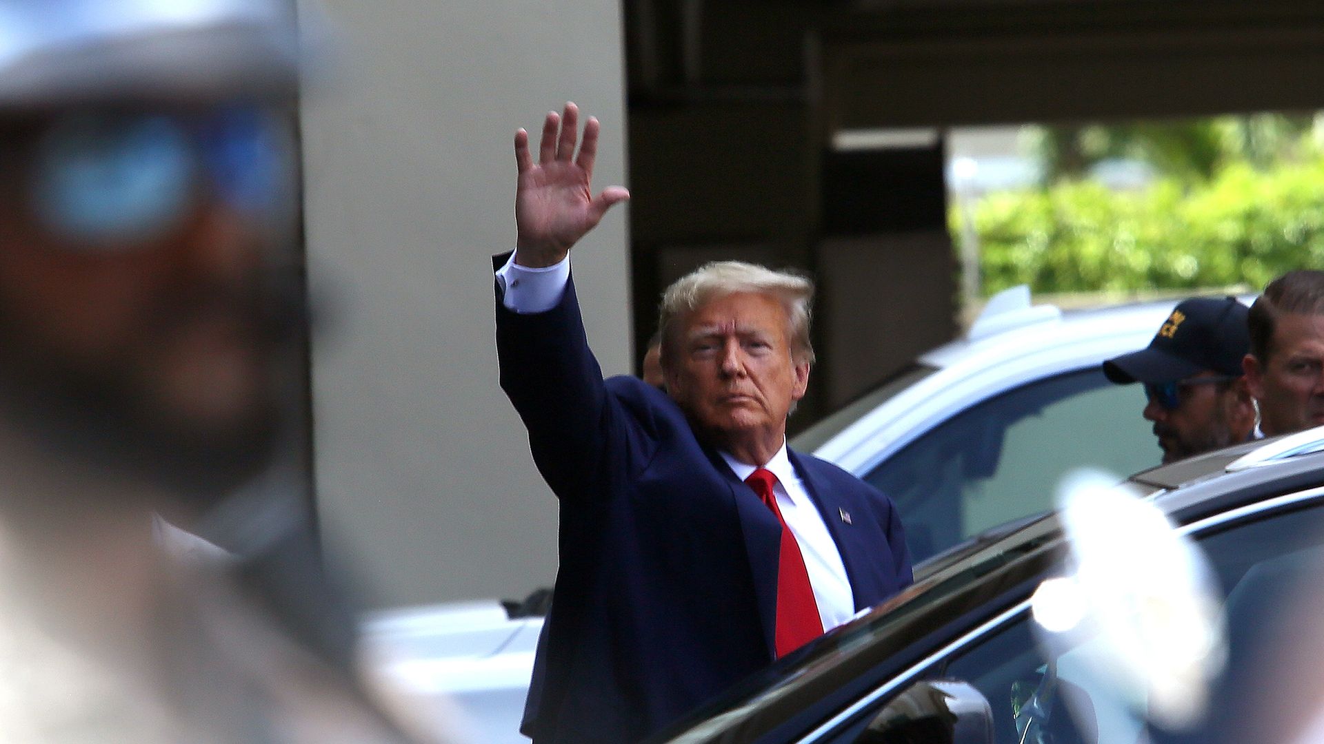Former U.S. President Donald Trump waves as he makes a visit to the Cuban restaurant Versailles after he appeared for his arraignment on June 13, 2023 in Miami, Florida.