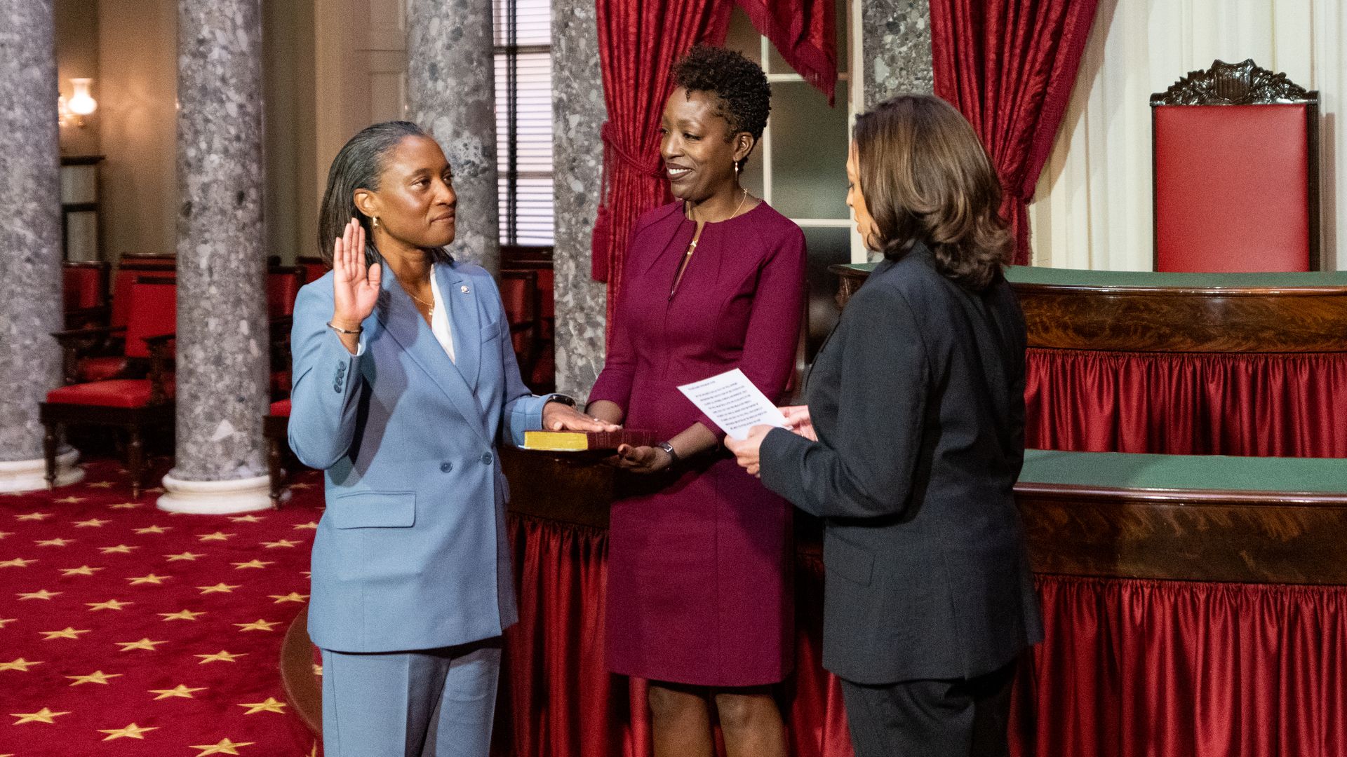 Laphonza Butler on the left with her wife Neneki Lee in the middle and Kamala Harris on the right reading swearing in text. 