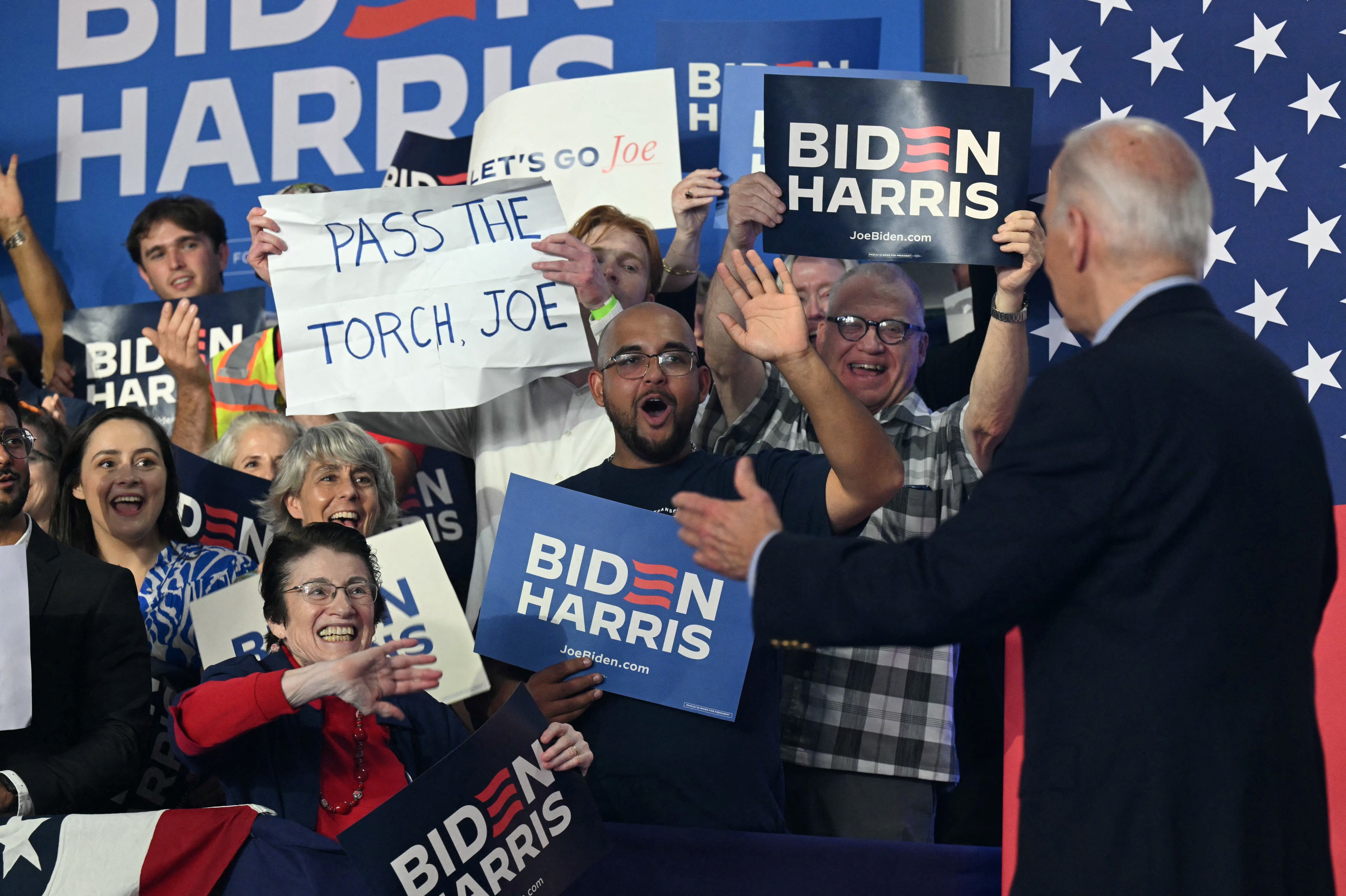 A handwritten sign held by an attendee at President Biden's event yesterday in Madison, Ws., says: "PASS THE TORCH, JOE." 