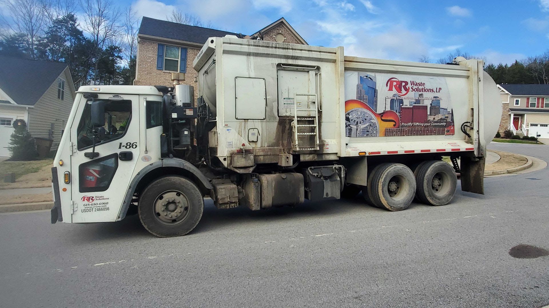 A Red River Waste Solutions truck in a suburban Nashville neighborhood.