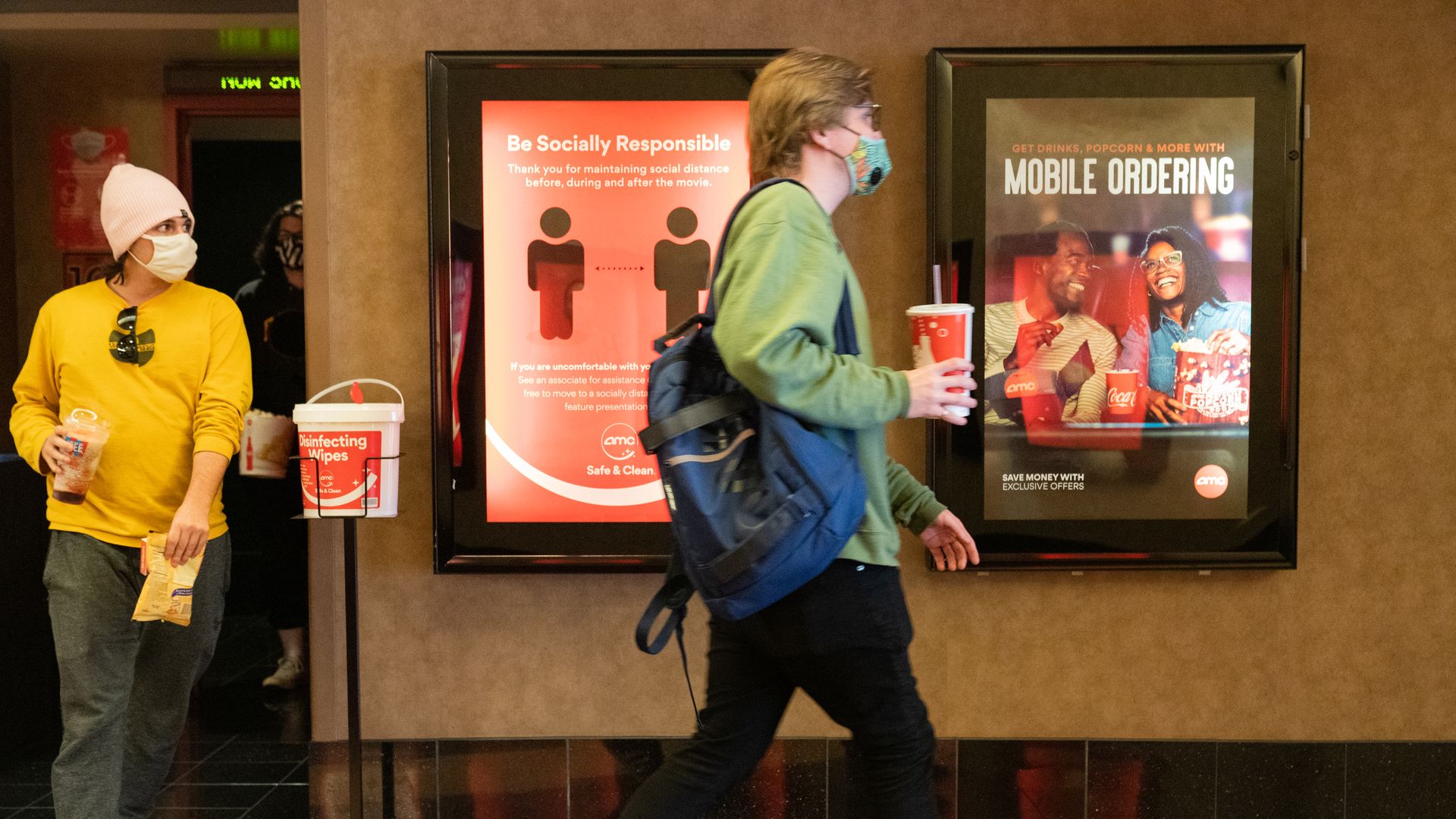 Moviegoers wear protective masks at the AMC movie theater at the Westfield Century City shopping mall in Los Angeles, California, U.S. on Monday, March 15, 2021
