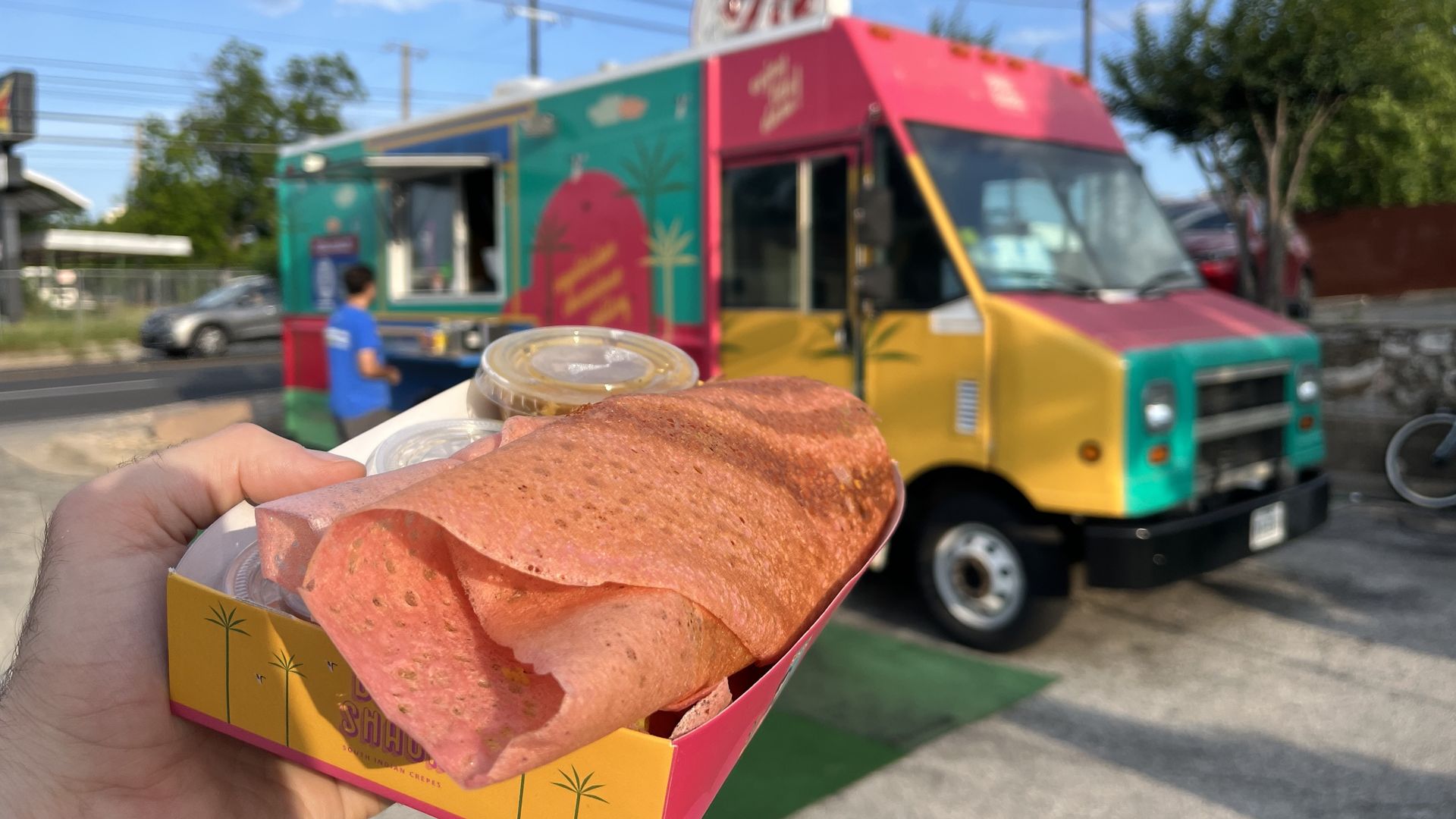 A dosa with Dosa Shack in the background