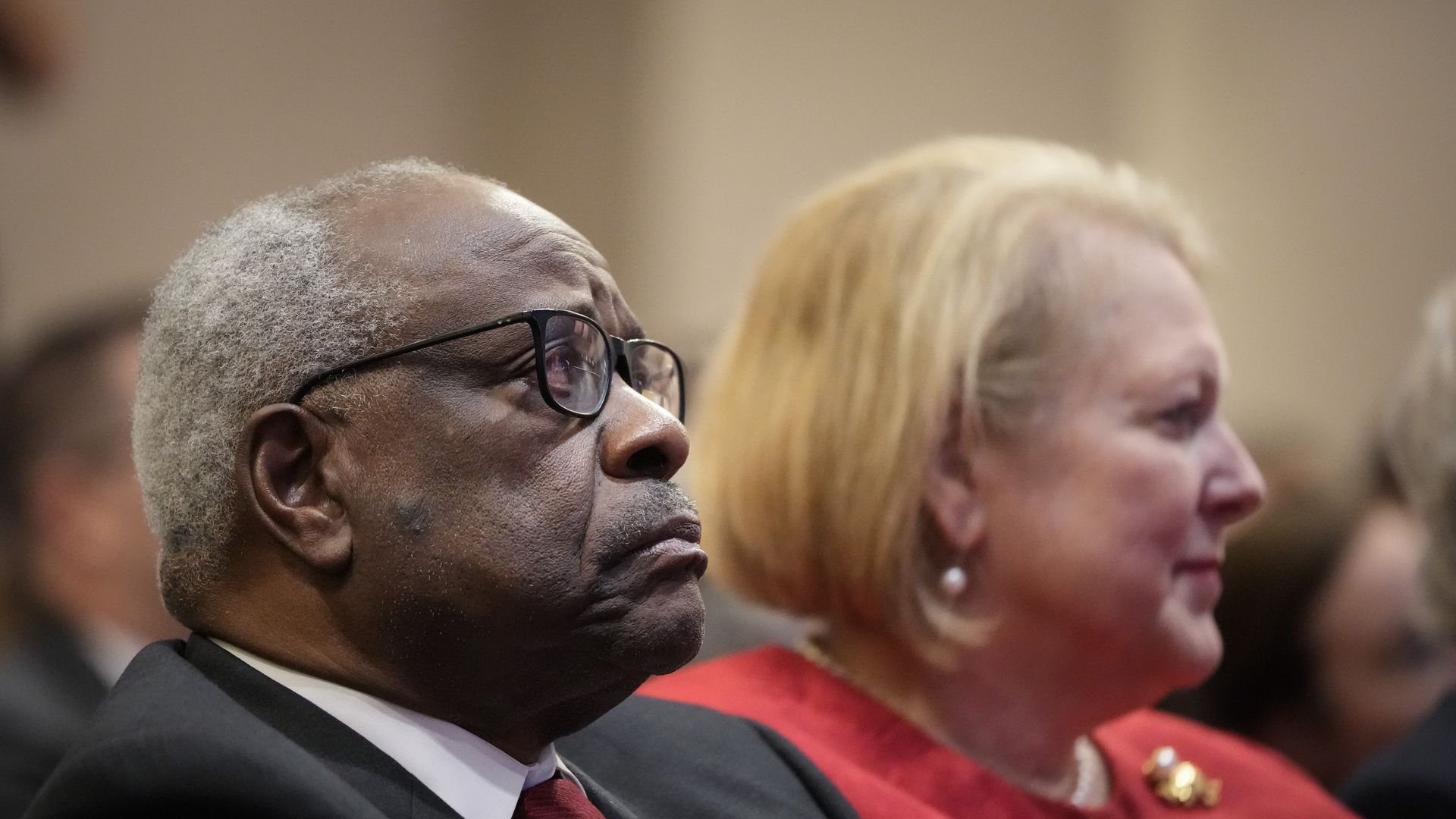 Associate Supreme Court Justice Clarence Thomas sits with his wife Virginia Thomas