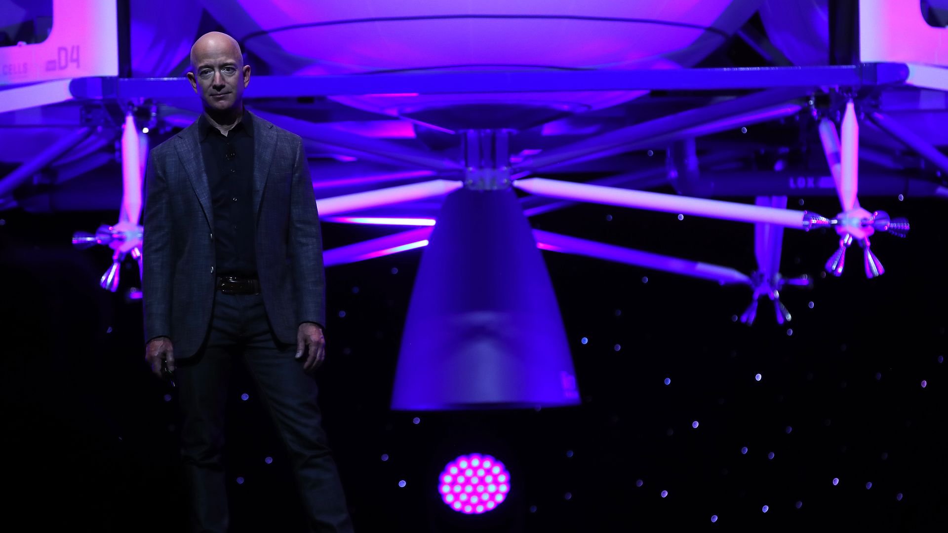Jeff Bezos stands in front of a moon lander